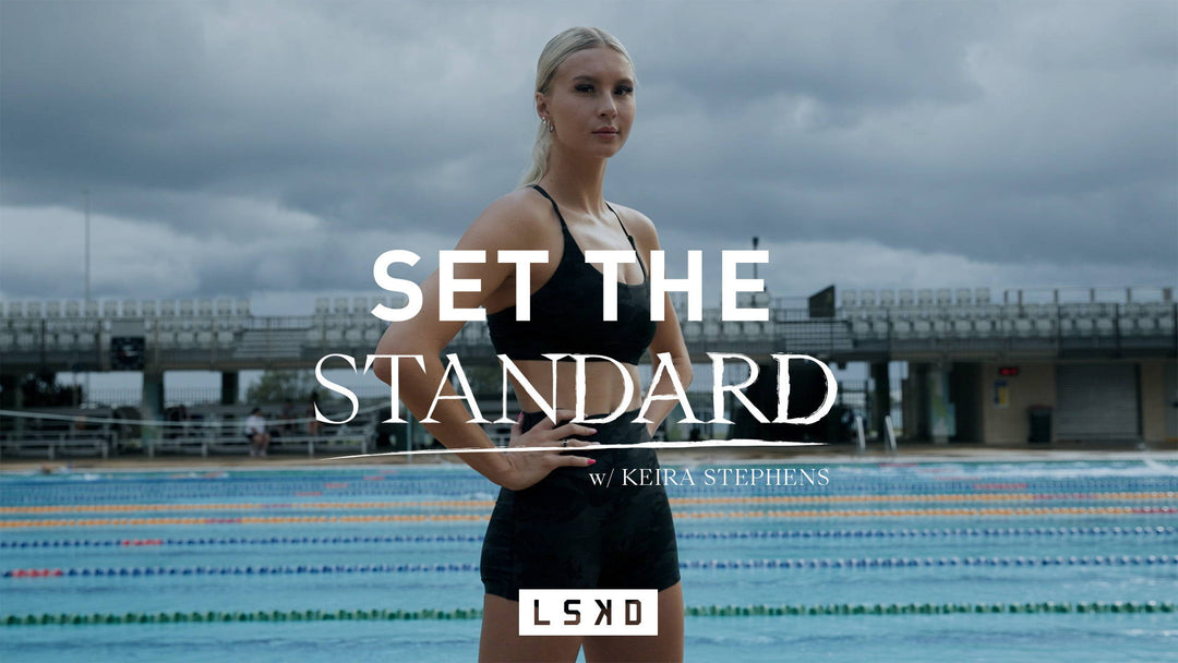 girl standing next to a swimming pool
