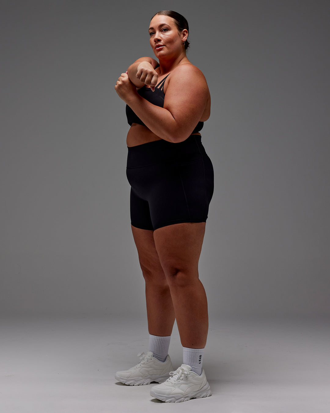 Woman wearing Fusion Ultra High-Rise 6" Short Pockets - Black | Model:Jordie | Size:2XL