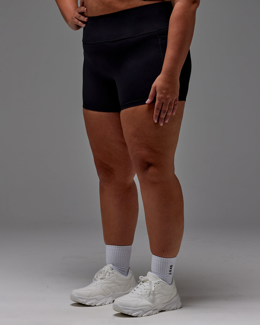 Woman wearing Fusion Ultra High-Rise 4" Short Pockets - Black | Model:Jordie | Size:2XL