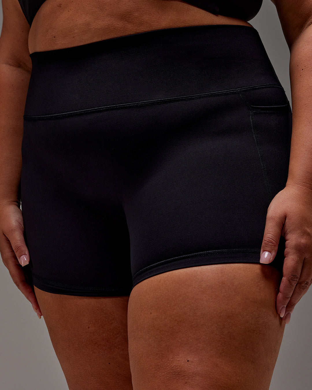 Woman wearing Fusion Ultra High-Rise 4" Short Pockets - Black | Model:Jordie | Size:2XL