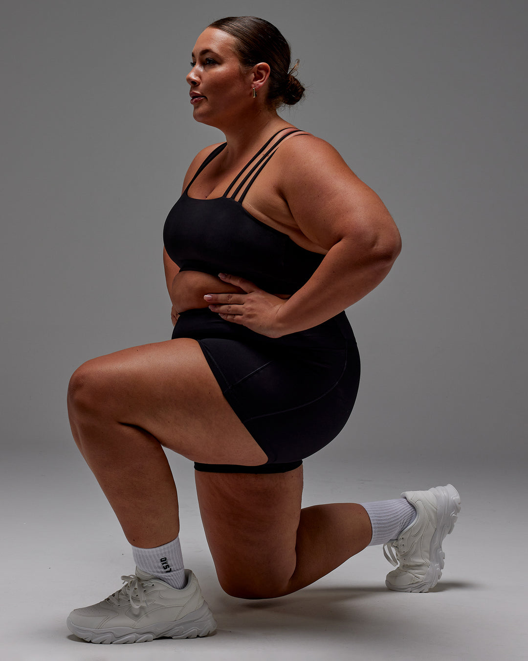 Woman wearing Fusion Ultra High-Rise 4" Short Pockets - Black | Model:Jordie | Size:2XL