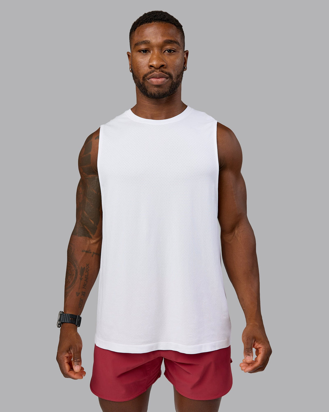 Model wearing AeroFLX+ Seamless Muscle Tank - White/White | Model:Sam | Size:L