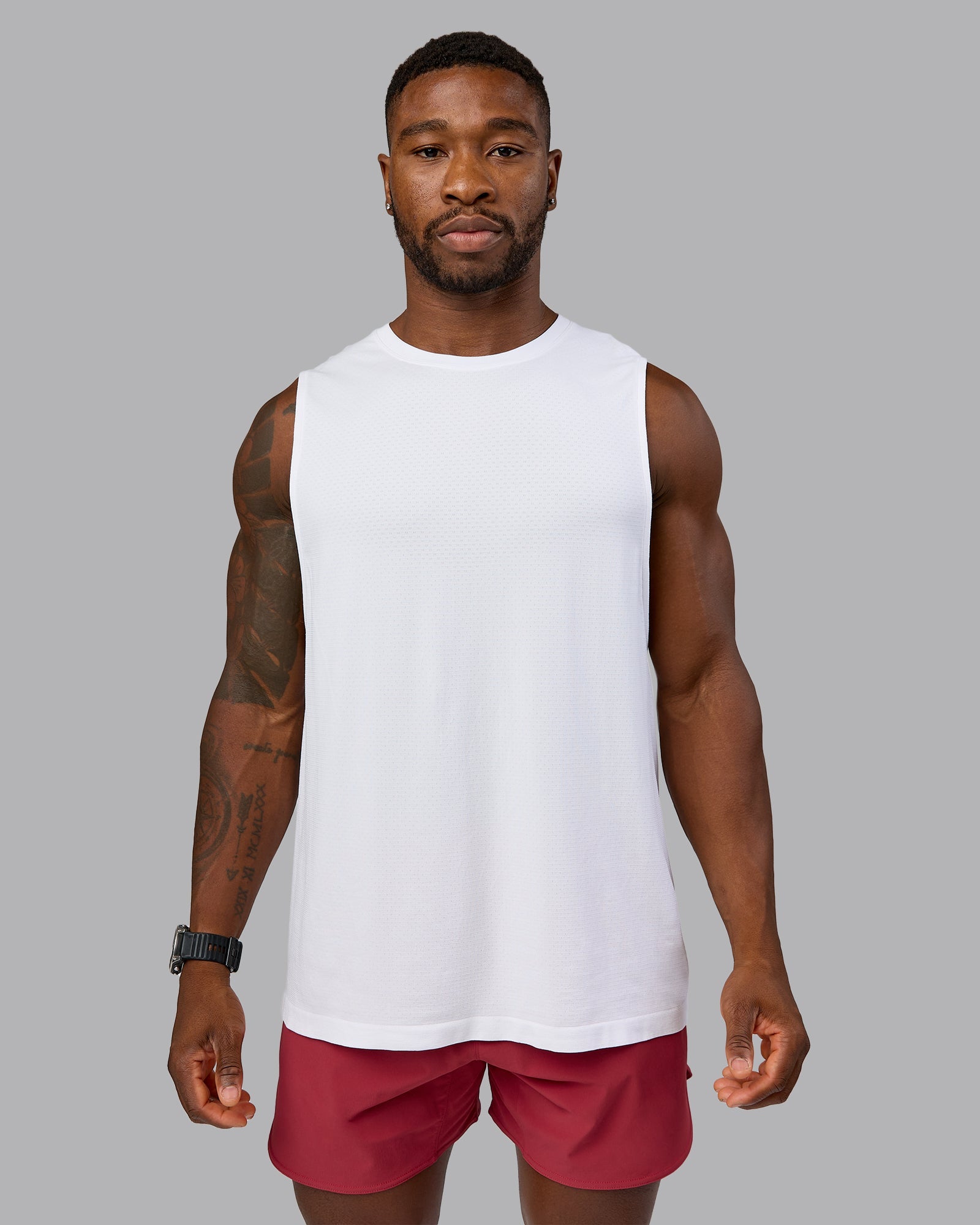 Model wearing AeroFLX+ Seamless Muscle Tank - White/White | Model:Sam | Size:L