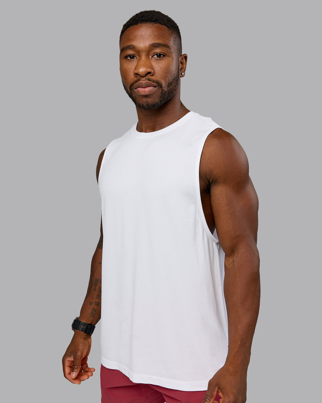 Model wearing AeroFLX+ Seamless Muscle Tank - White/White | Model:Sam | Size:L