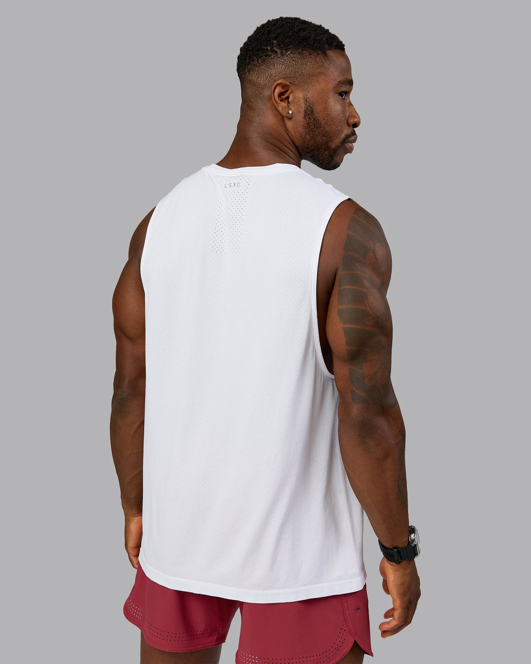 Model wearing AeroFLX+ Seamless Muscle Tank - White/White | Model:Sam | Size:L