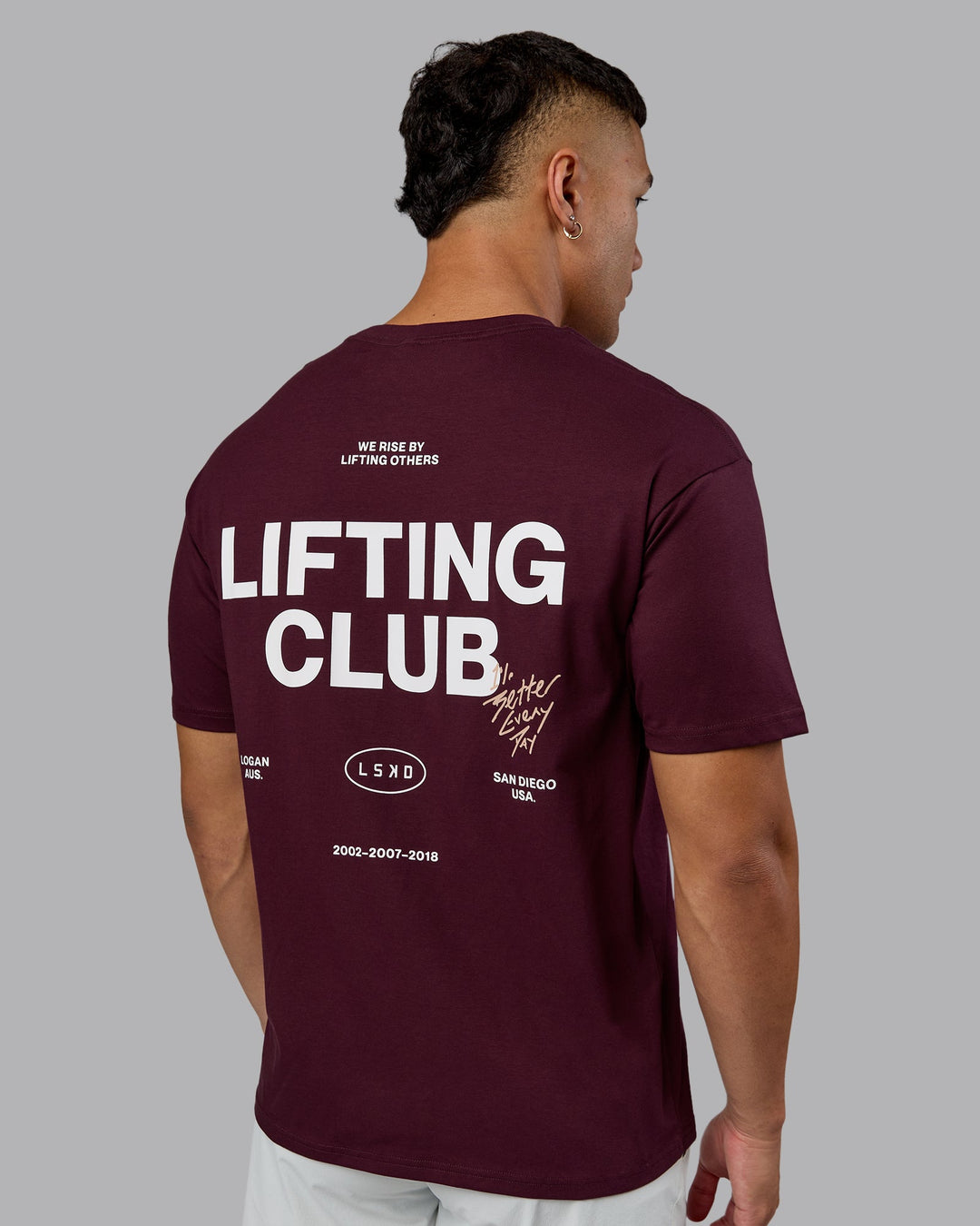 Man wearing Lifting Club FLXCotton Tee Oversize - Cherry Lacquer-White | Model:Kaelyb | Size:L