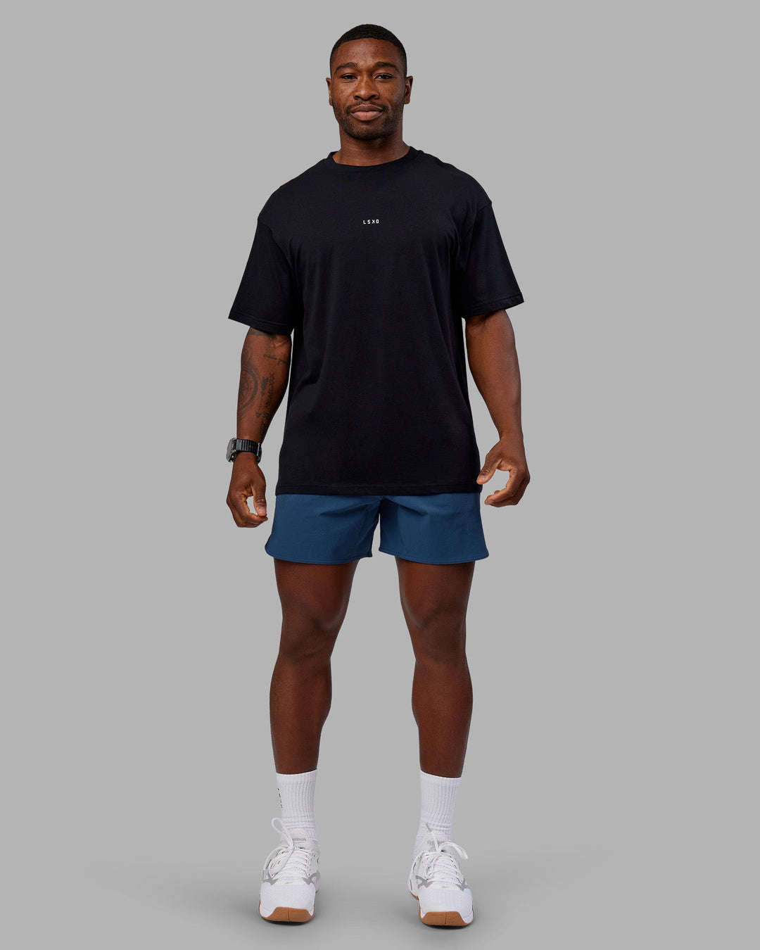 Man wearing Base FLXCotton Tee Oversized - Black | Model:Sam | Size:L