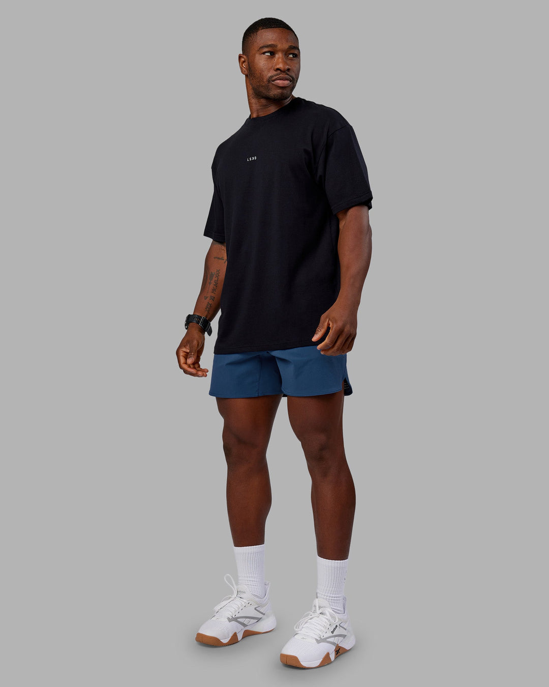 Man wearing Base FLXCotton Tee Oversized - Black | Model:Sam | Size:L