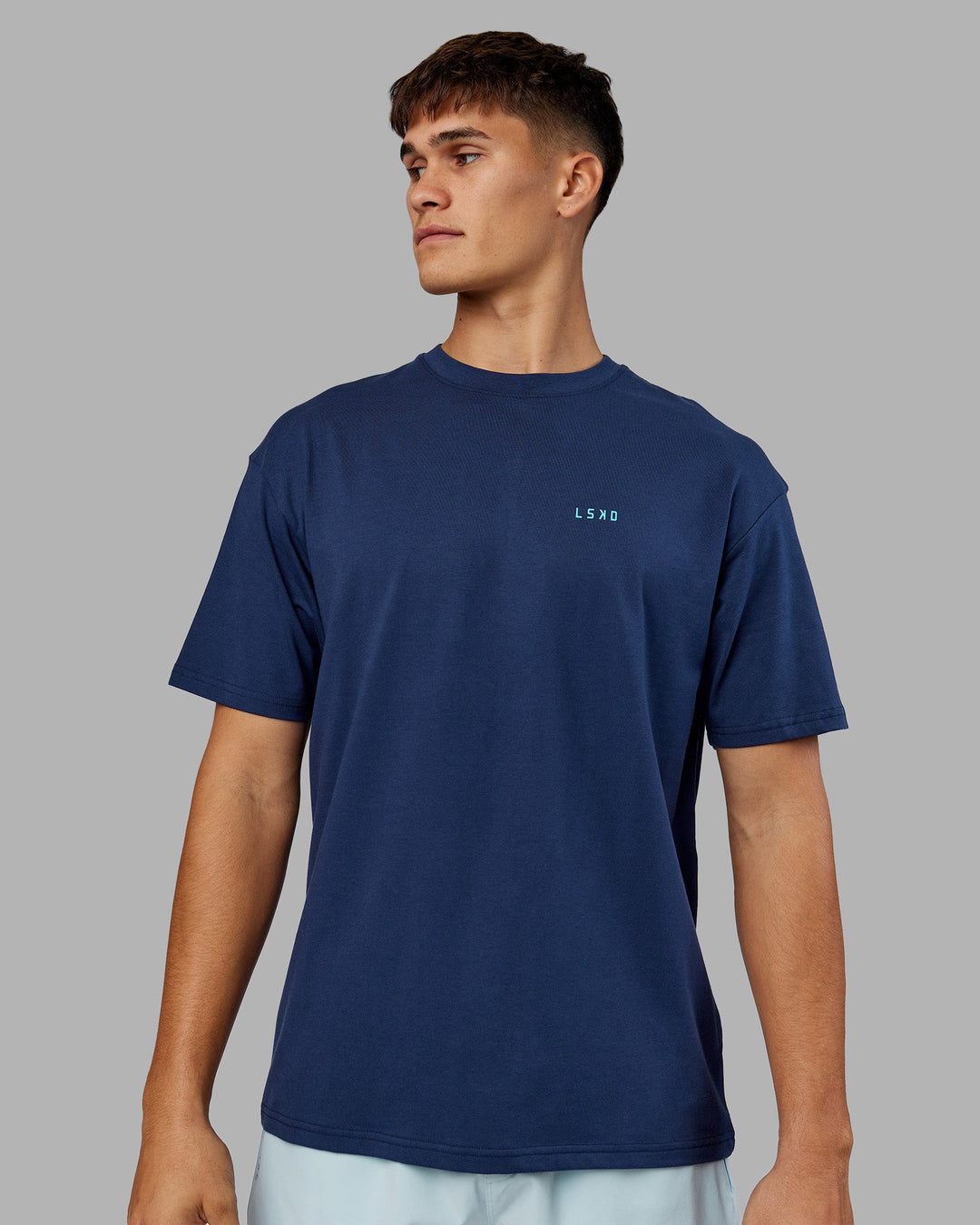 Man wearing Enjoy the Journey Value Series FLXCotton Tee Oversize - Future Navy-Blue Atoll | Model:Jackson | Size:L