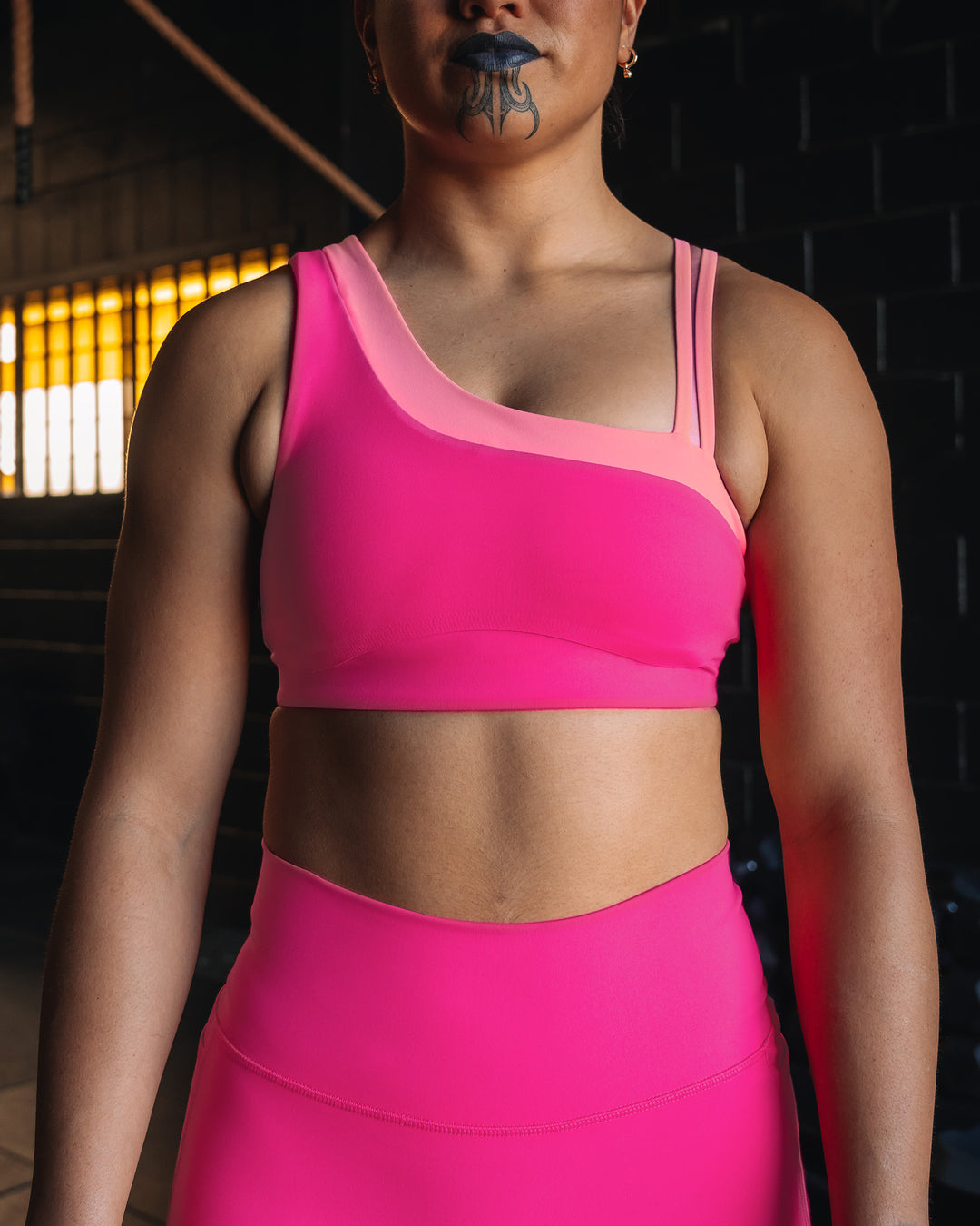 Woman wearing Thrive Asymmetric Sports Bra - Ultra Pink-Candy Pink | Model:Teraipine | Size:M
