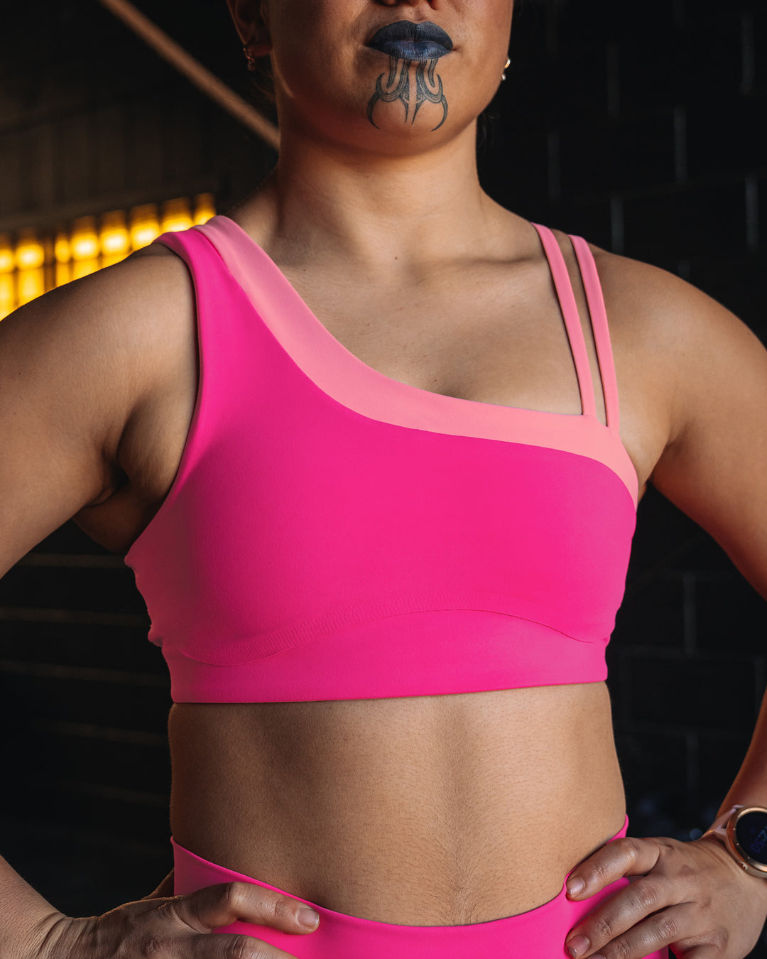 Woman wearing Thrive Asymmetric Sports Bra - Ultra Pink-Candy Pink | Model:Teraipine | Size:M
