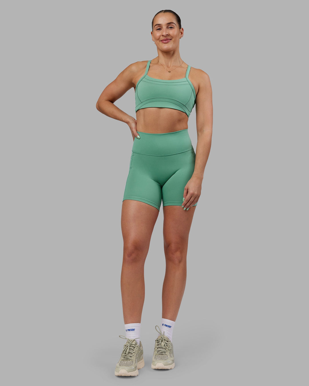 Woman wearing Abs Ignite Sports Bra - Matcha Green | Model:Abbey | Size:M
