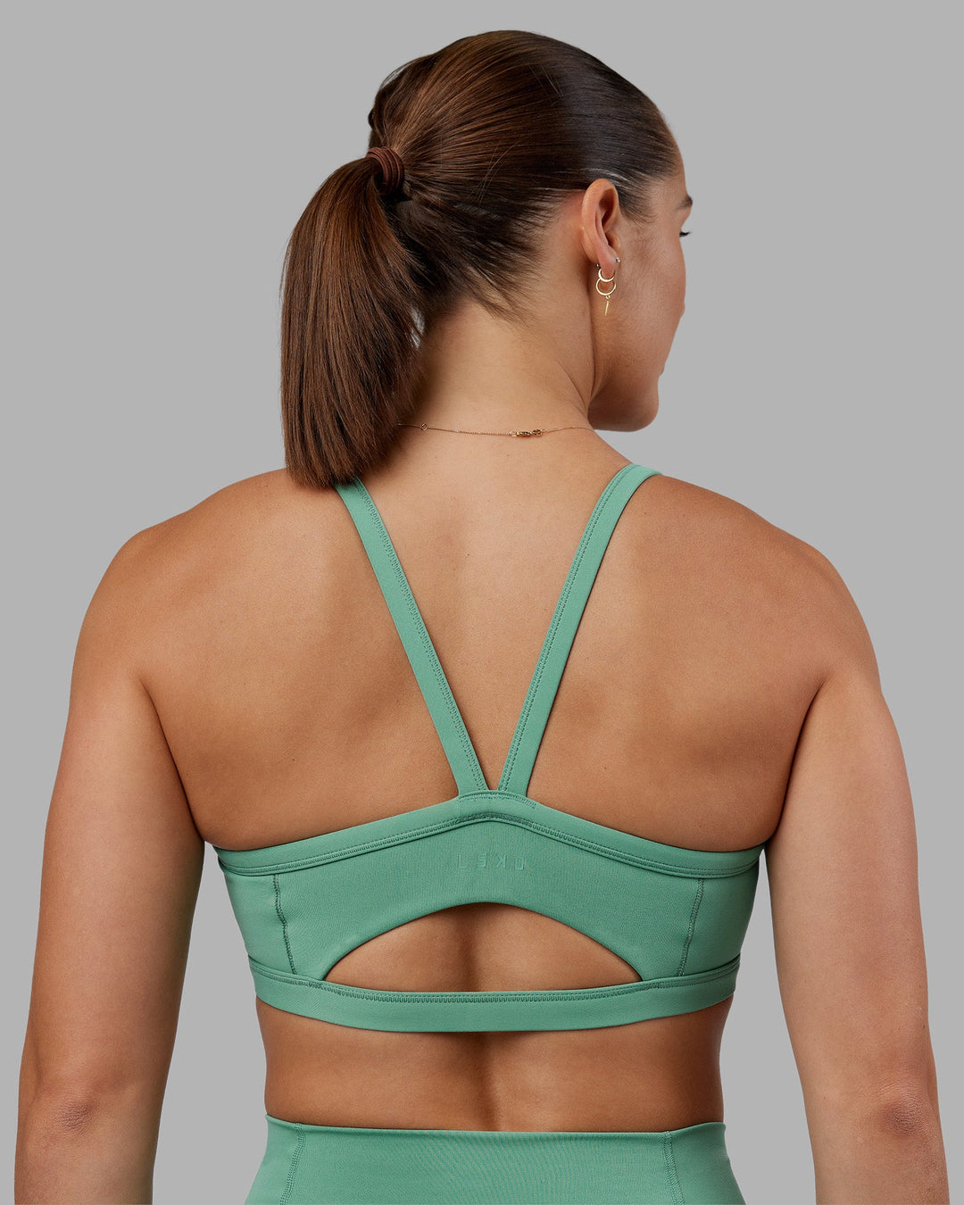 Woman wearing Abs Ignite Sports Bra - Matcha Green | Model:Abbey | Size:M