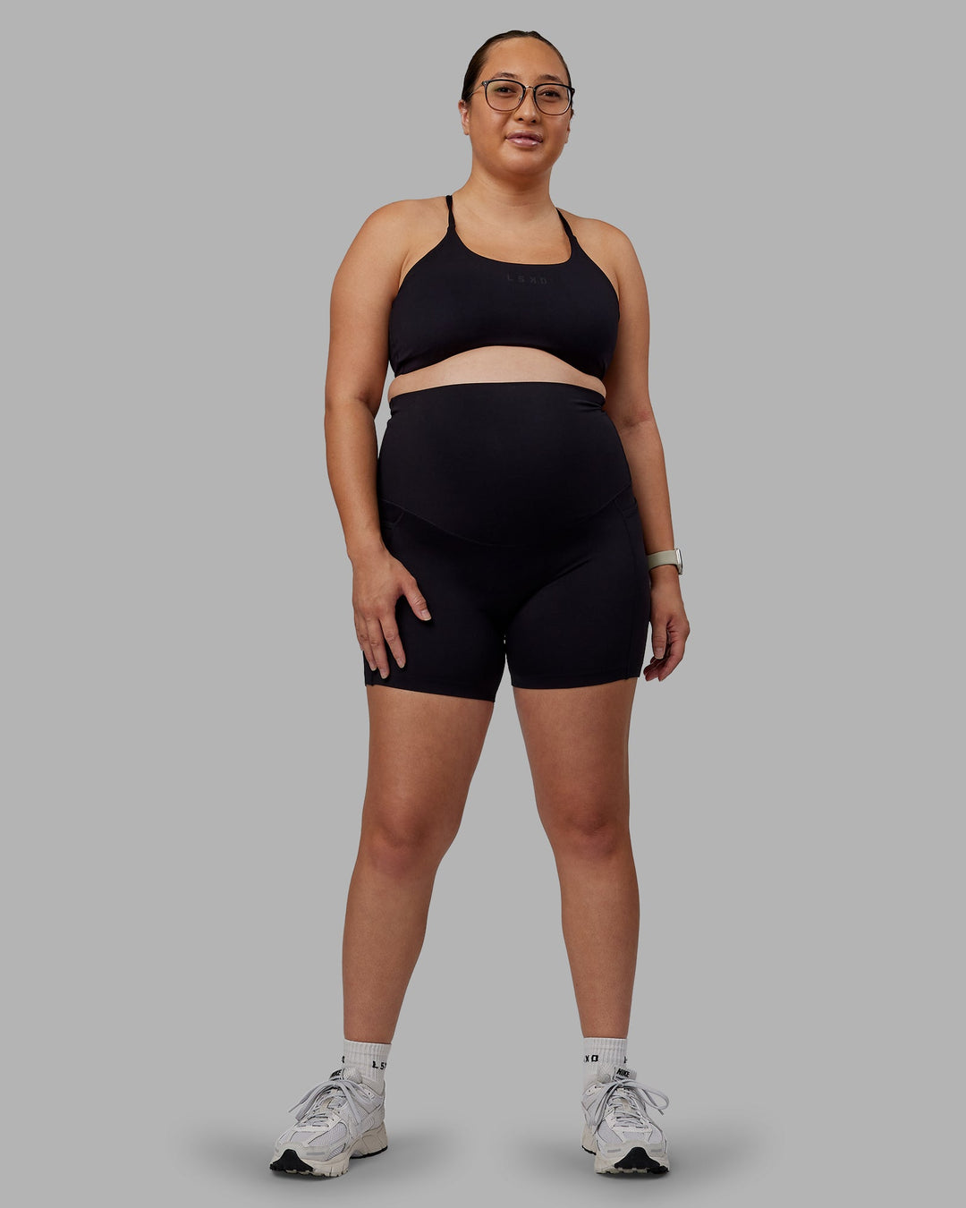 Woman wearing Elixir Ultra High-Rise Maternity 6" Short Pockets - Black | Model:Nevada | Size:M