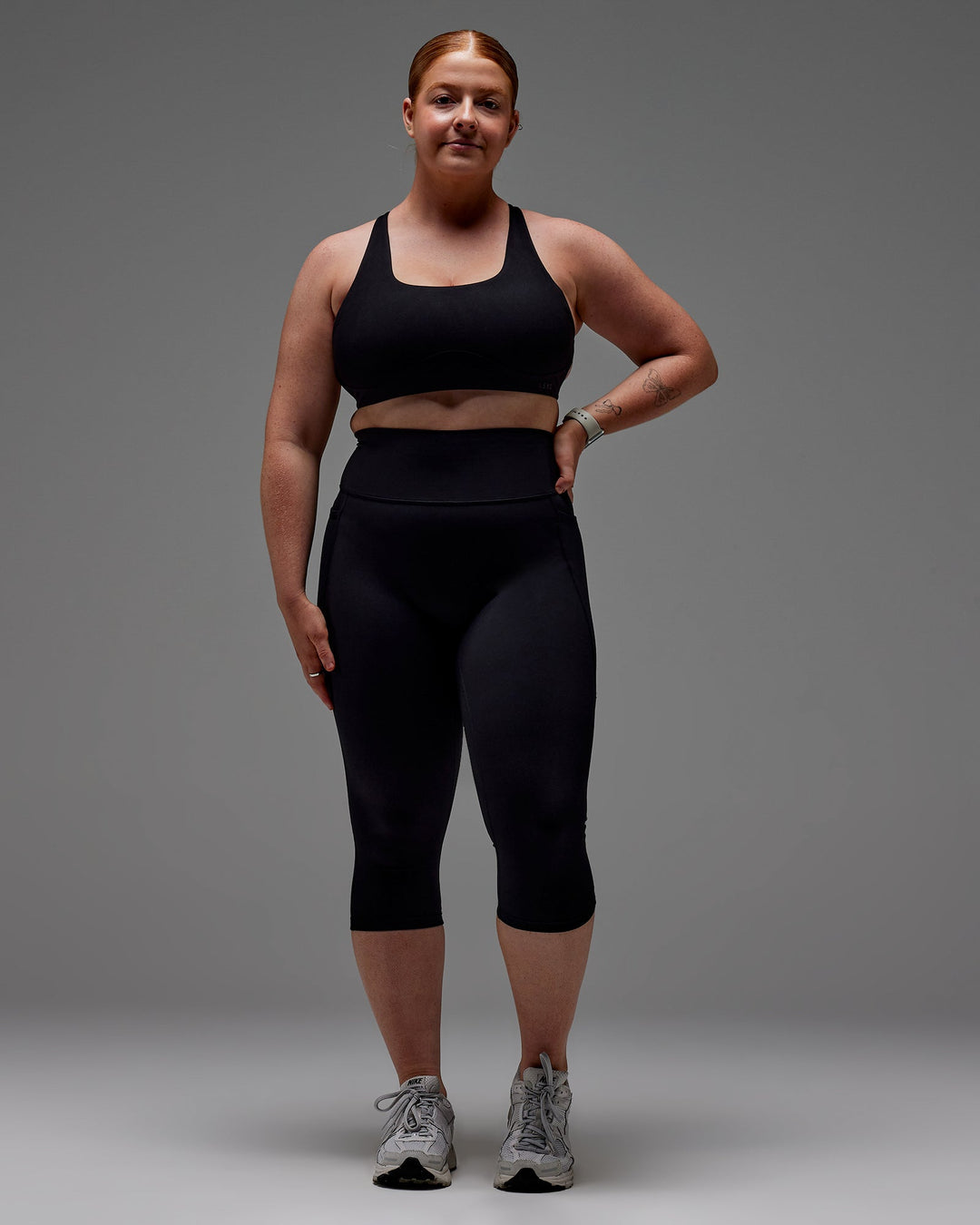 Woman wearing Fusion Ultra High-Rise 3/4 Legging Pockets - Black | Model:Caity | Size:M
