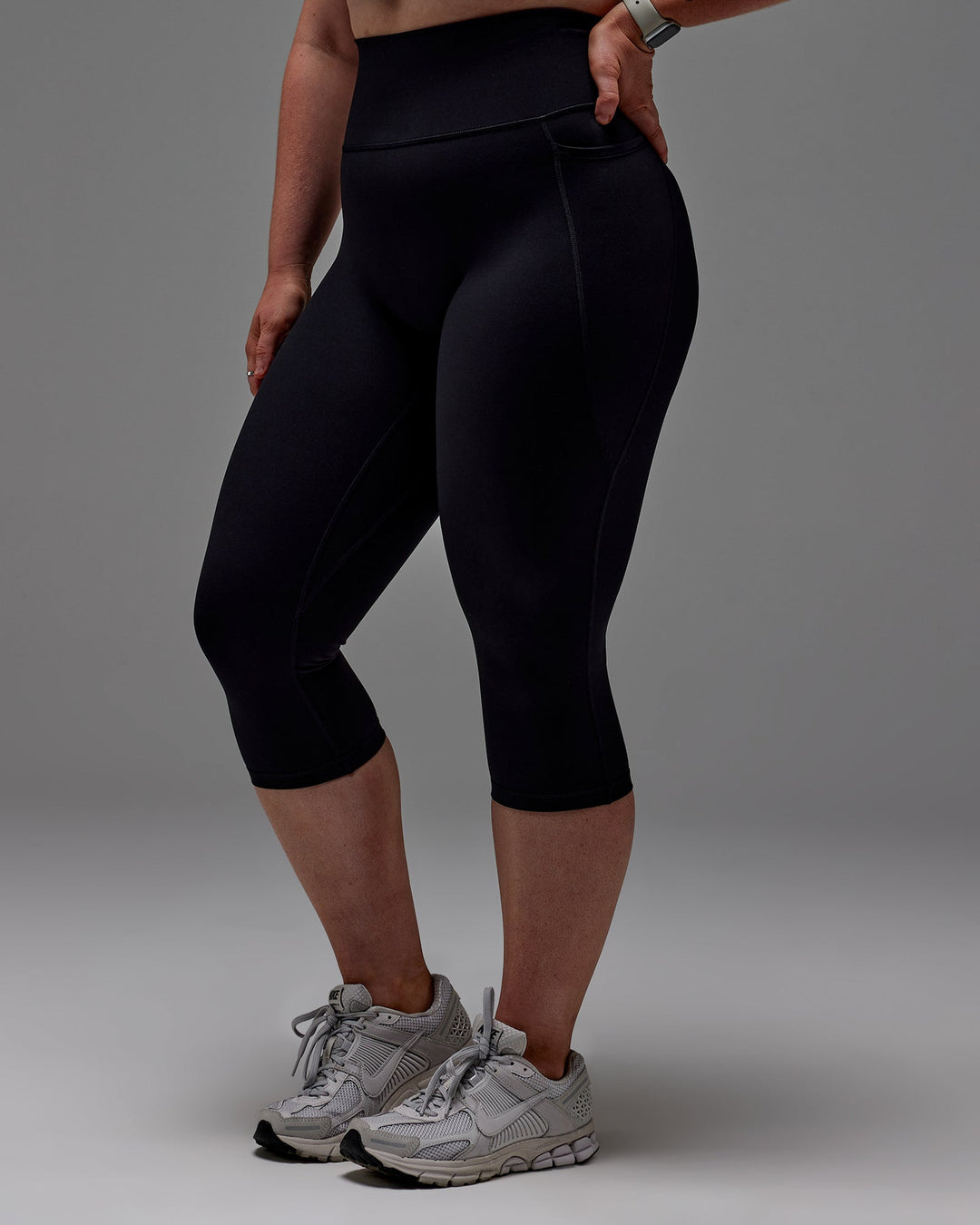 Woman wearing Fusion Ultra High-Rise 3/4 Legging Pockets - Black | Model:Caity | Size:M