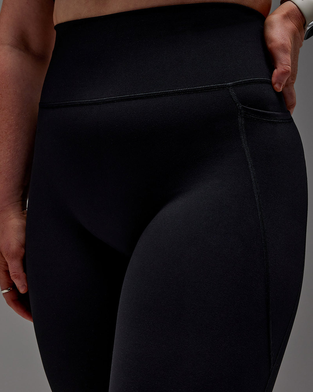 Woman wearing Fusion Ultra High-Rise 3/4 Legging Pockets - Black | Model:Caity | Size:M