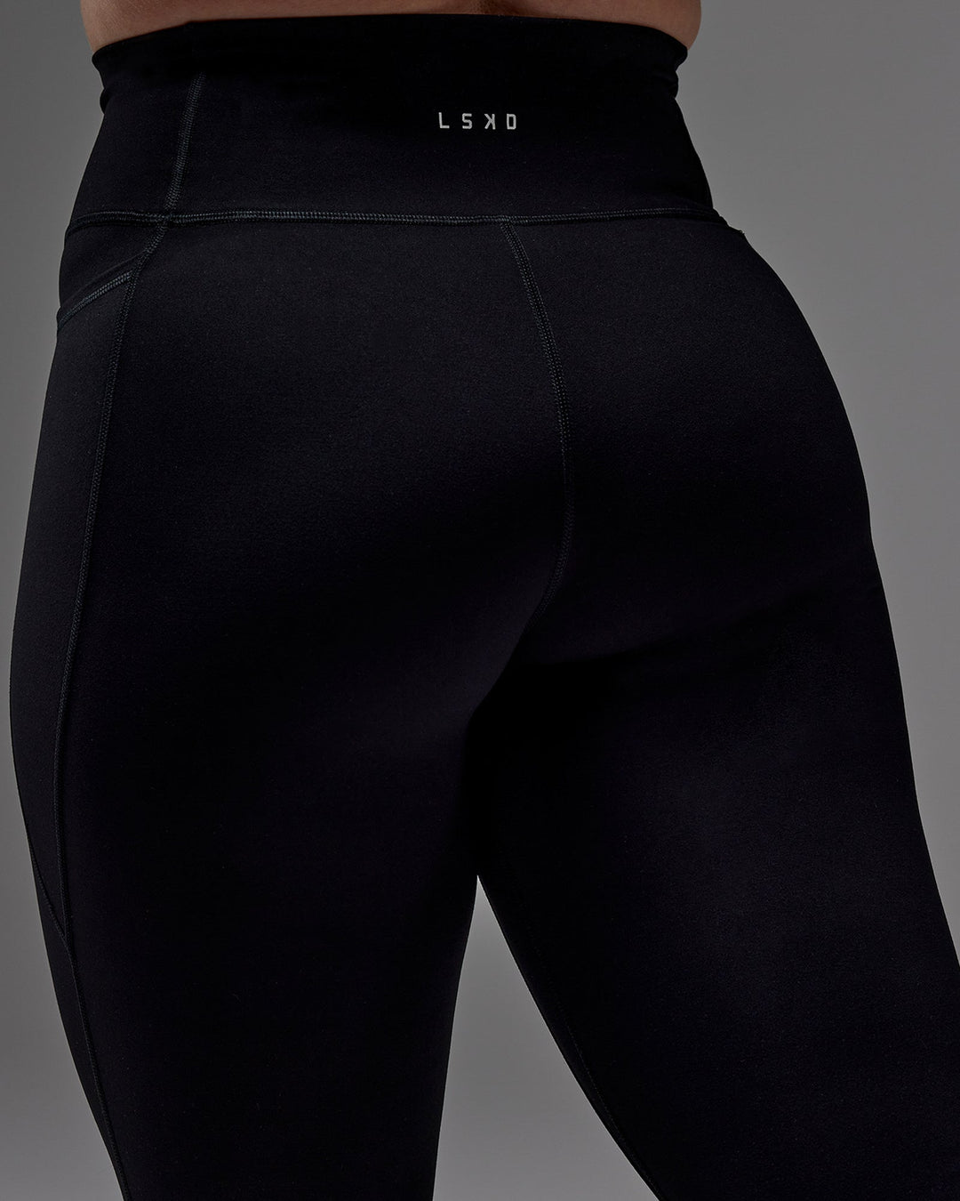 Woman wearing Fusion Ultra High-Rise 3/4 Legging Pockets - Black | Model:Caity | Size:M