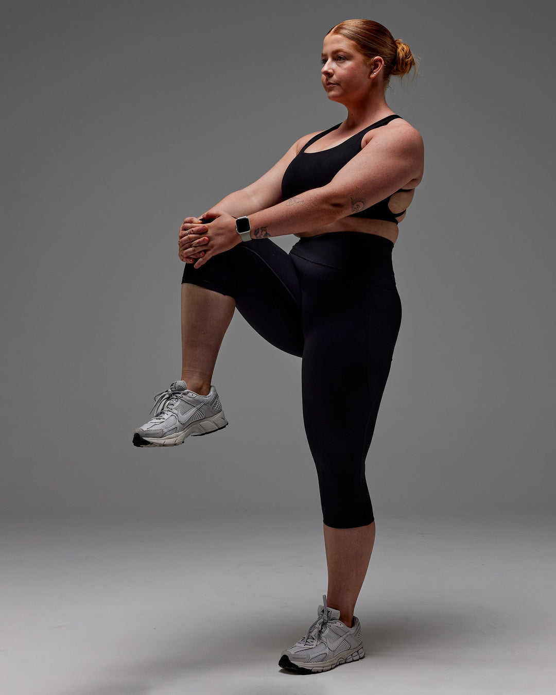 Woman wearing Fusion Ultra High-Rise 3/4 Legging Pockets - Black | Model:Caity | Size:M