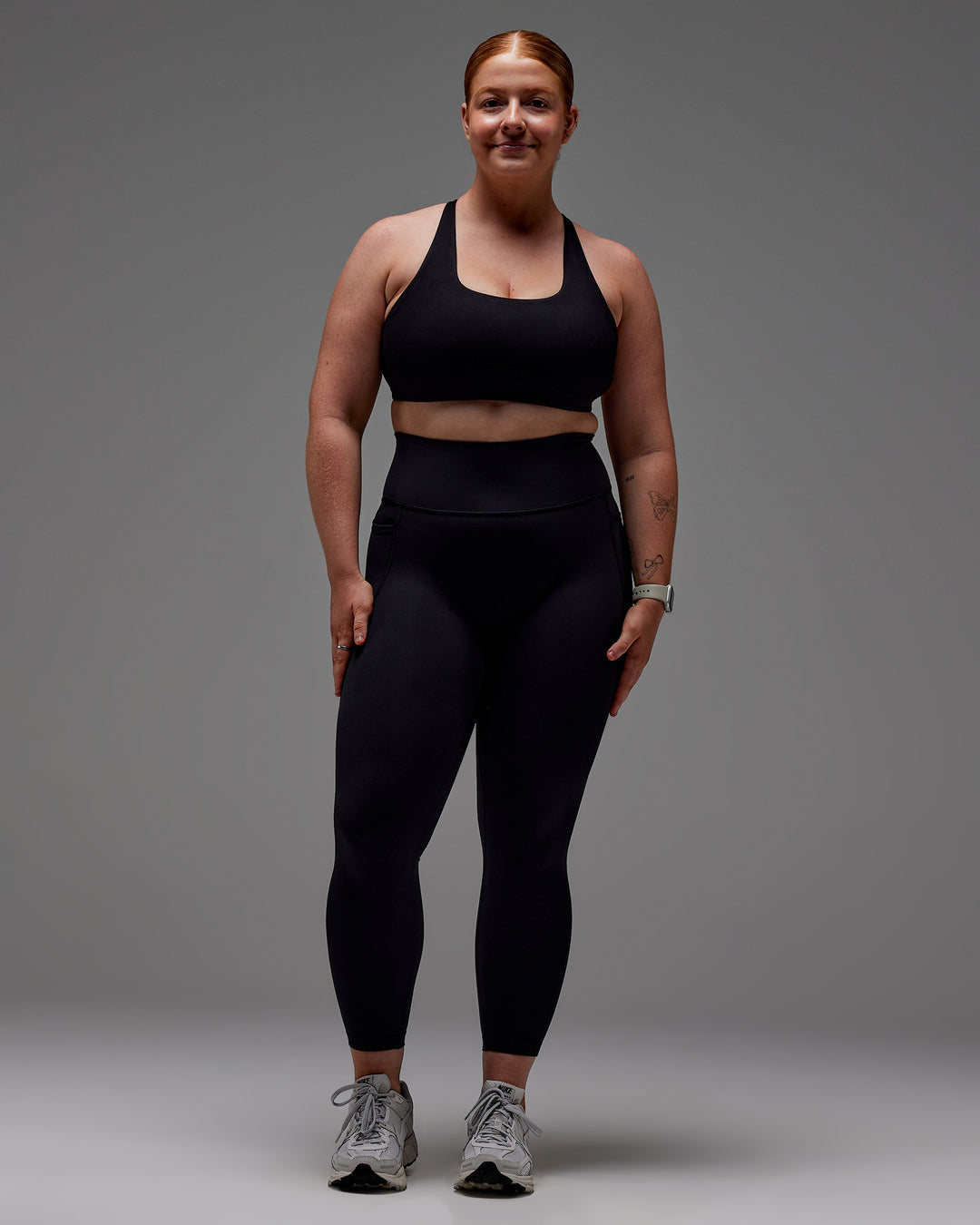 Woman wearing Fusion Ultra High-Rise 7/8 Legging Pockets - Black | Model:Caity | Size:M