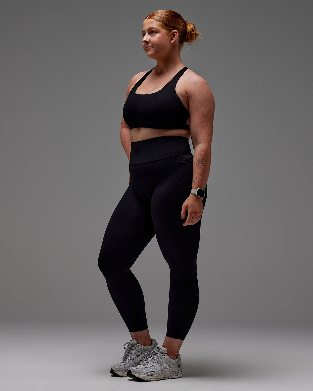 Woman wearing Fusion Ultra High-Rise 7/8 Legging Pockets - Black | Model:Caity | Size:M