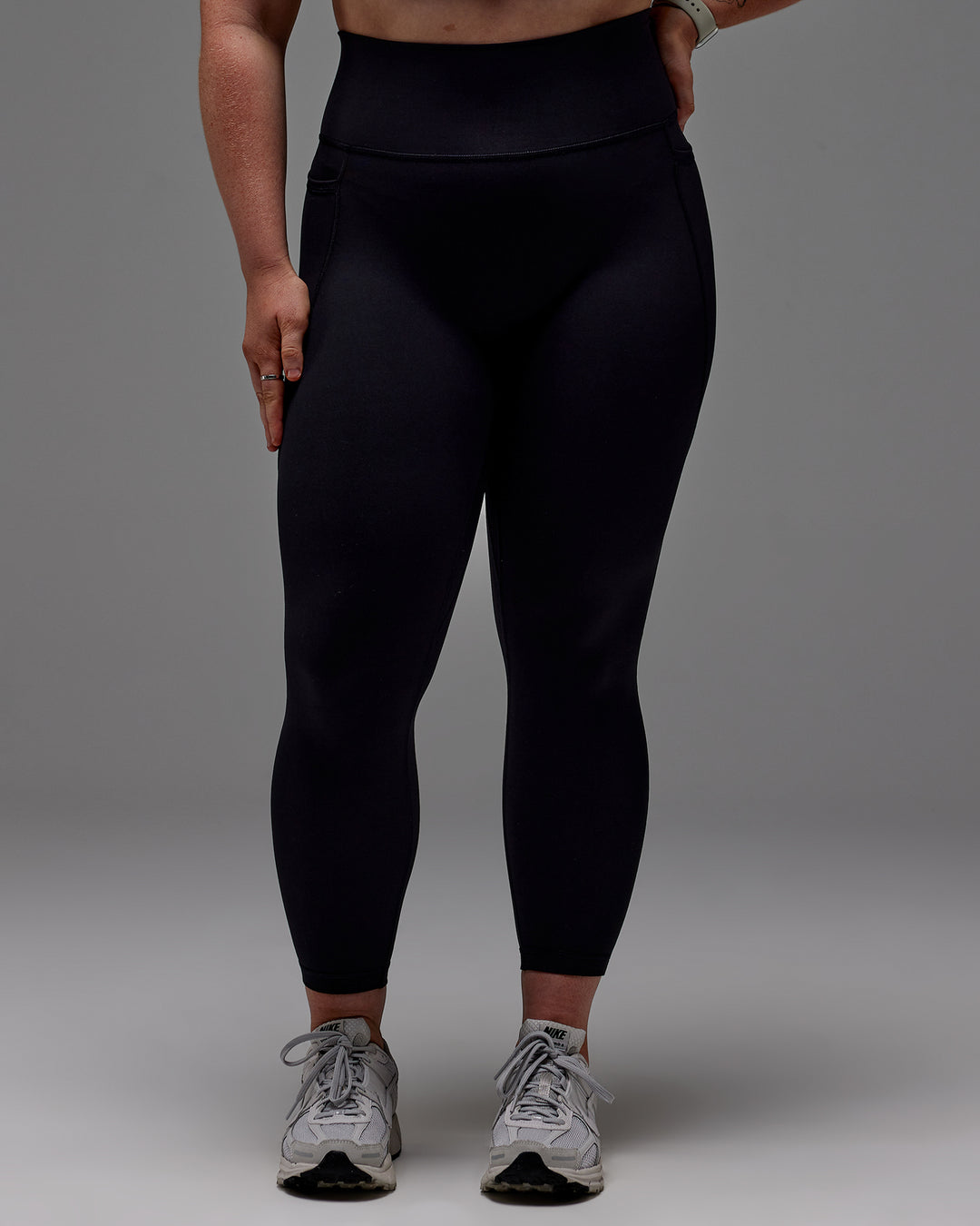 Woman wearing Fusion Ultra High-Rise 7/8 Legging Pockets - Black | Model:Caity | Size:M