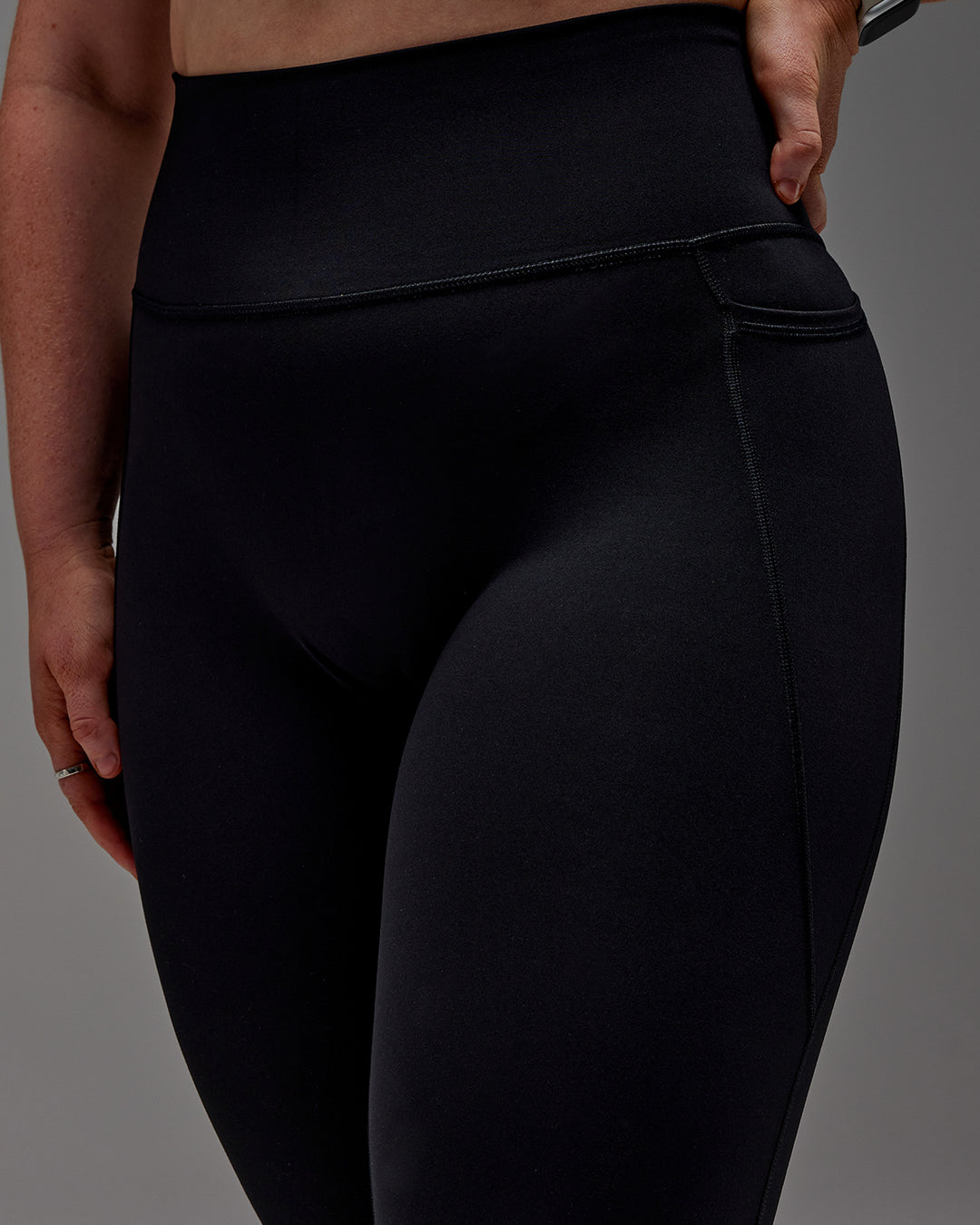 Woman wearing Fusion Ultra High-Rise 7/8 Legging Pockets - Black | Model:Caity | Size:M