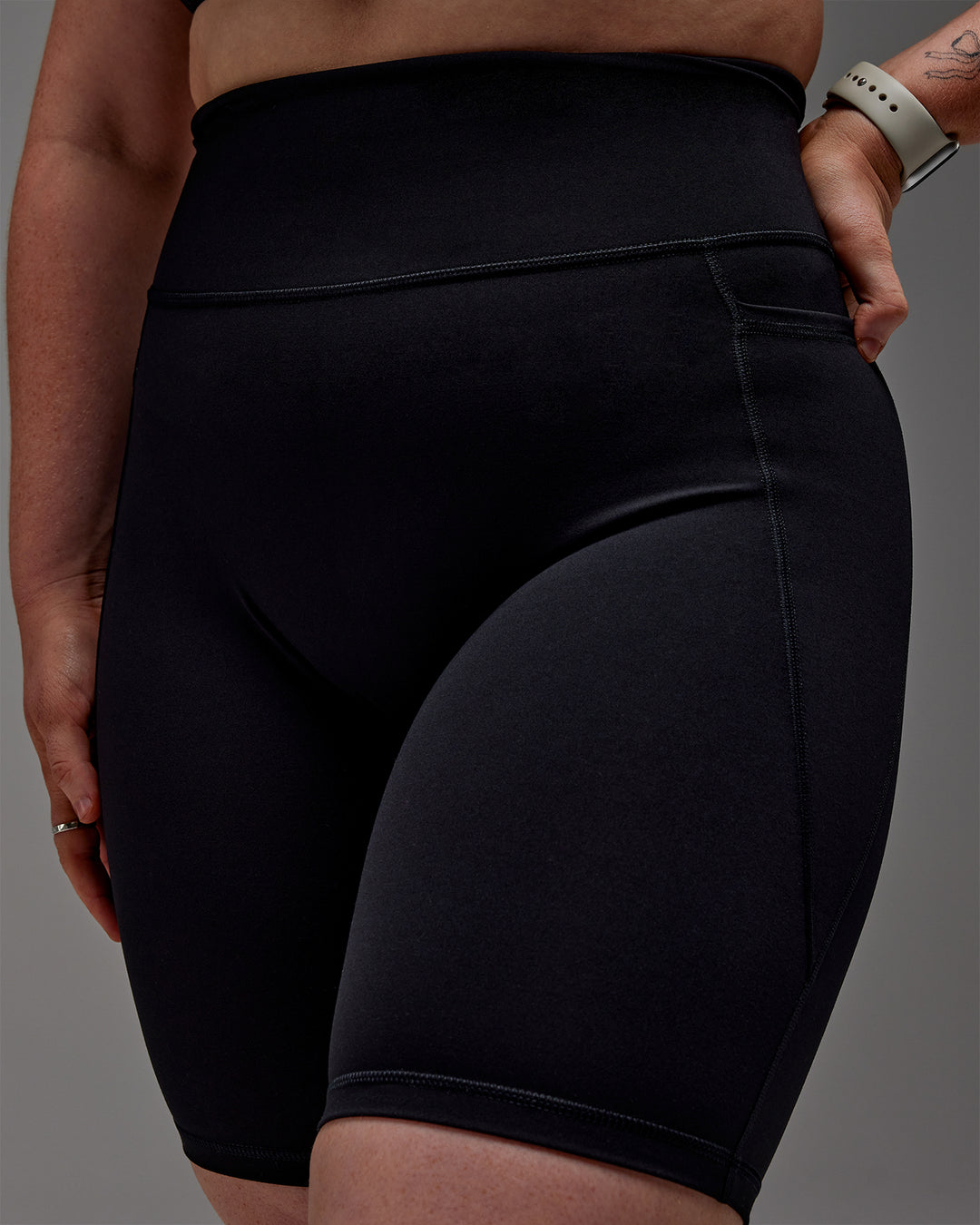 Woman wearing Fusion Ultra High-Rise 9" Short Pockets - Black | Model:Caity | Size:M