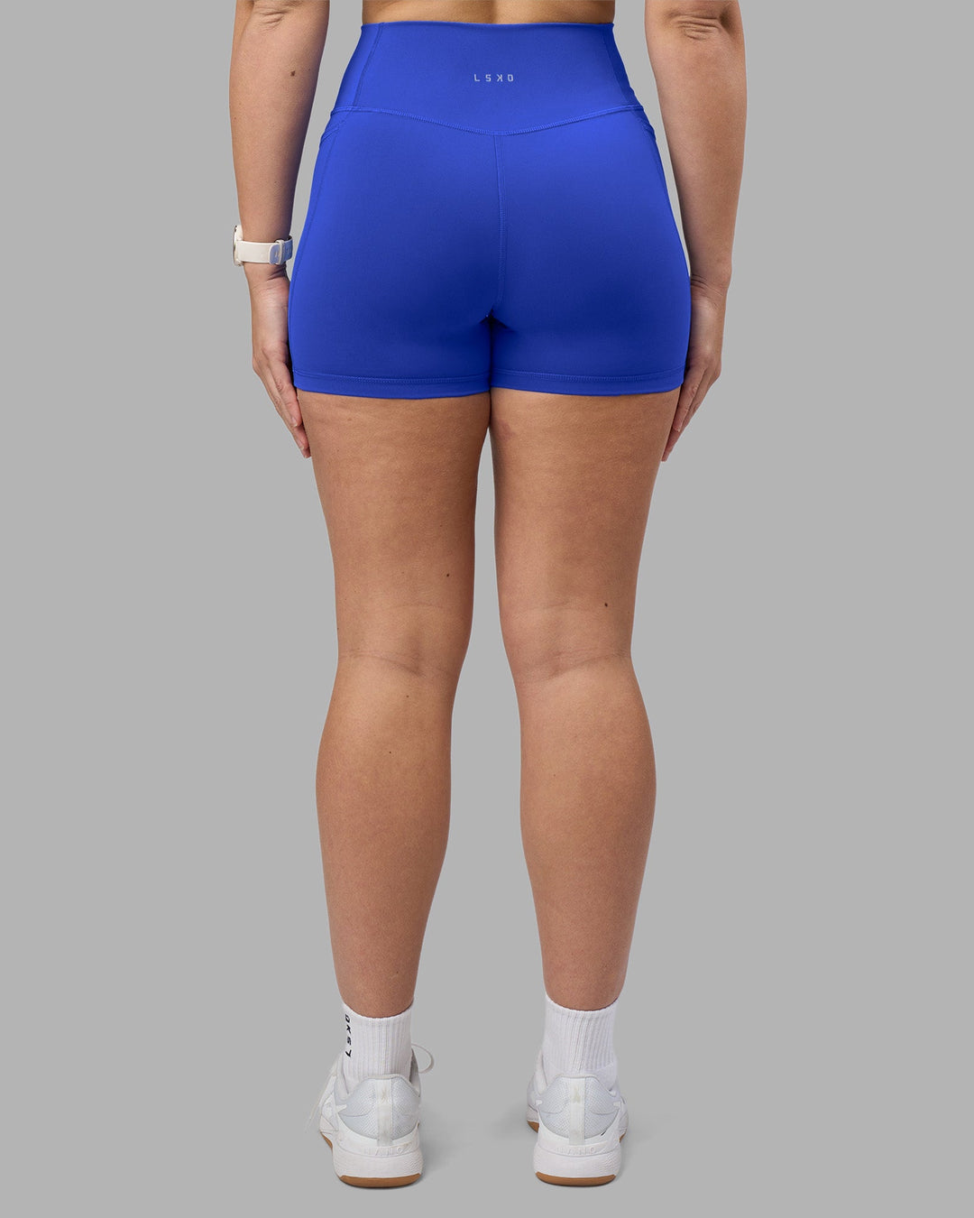 Woman wearing Fusion Ultra High-Rise 4" Short Pockets - Power Cobalt | Model:Amy | Size:M