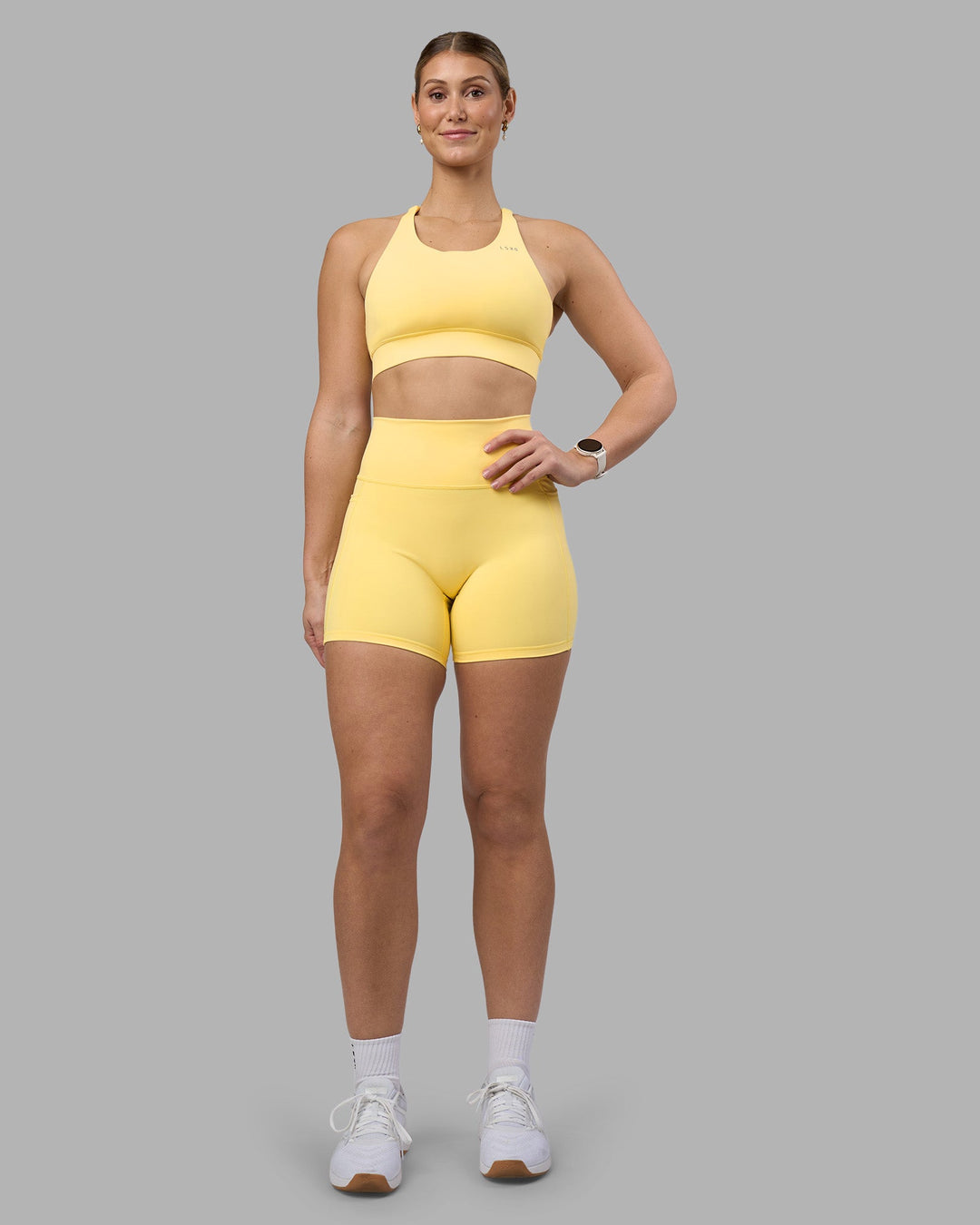 Woman wearing Fusion Ultra High-Rise 6" Short Pockets - Lemon | Model:Amy | Size:M