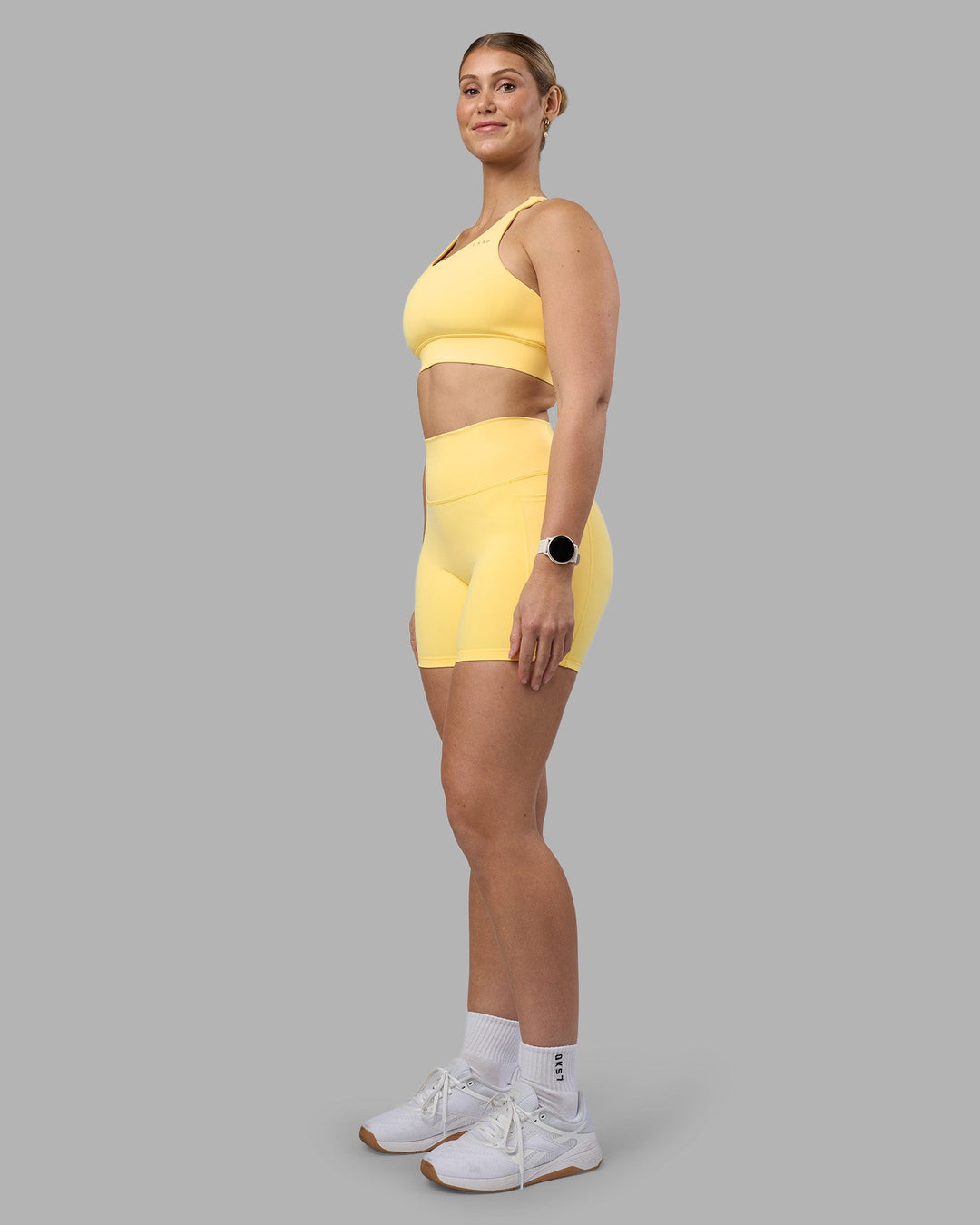 Woman wearing Fusion Ultra High-Rise 6" Short Pockets - Lemon | Model:Amy | Size:M