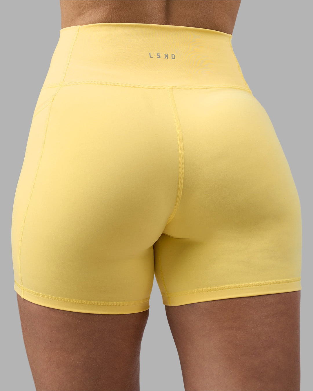 Woman wearing Fusion Ultra High-Rise 6" Short Pockets - Lemon | Model:Amy | Size:M