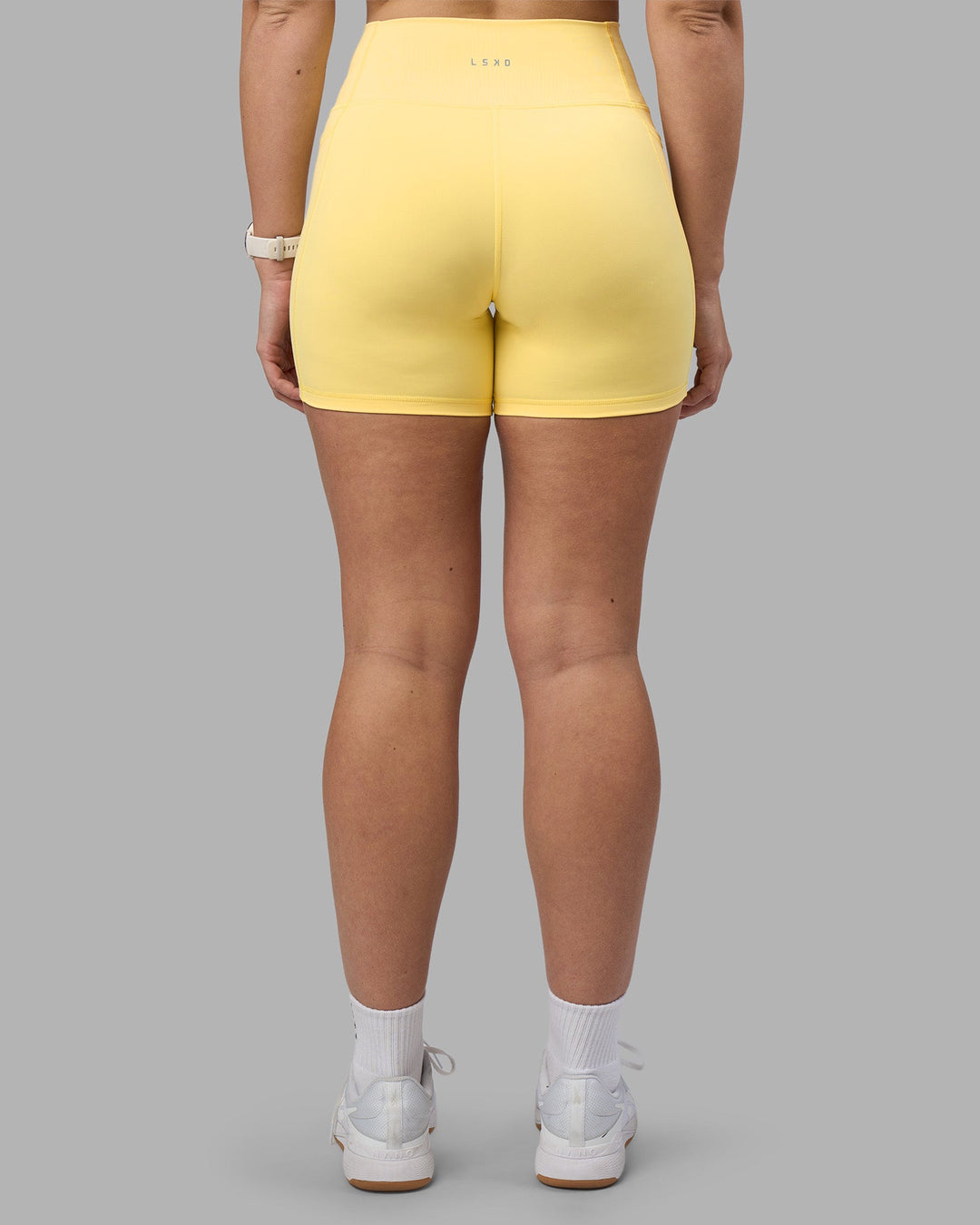 Woman wearing Fusion Ultra High-Rise 6" Short Pockets - Lemon | Model:Amy | Size:M