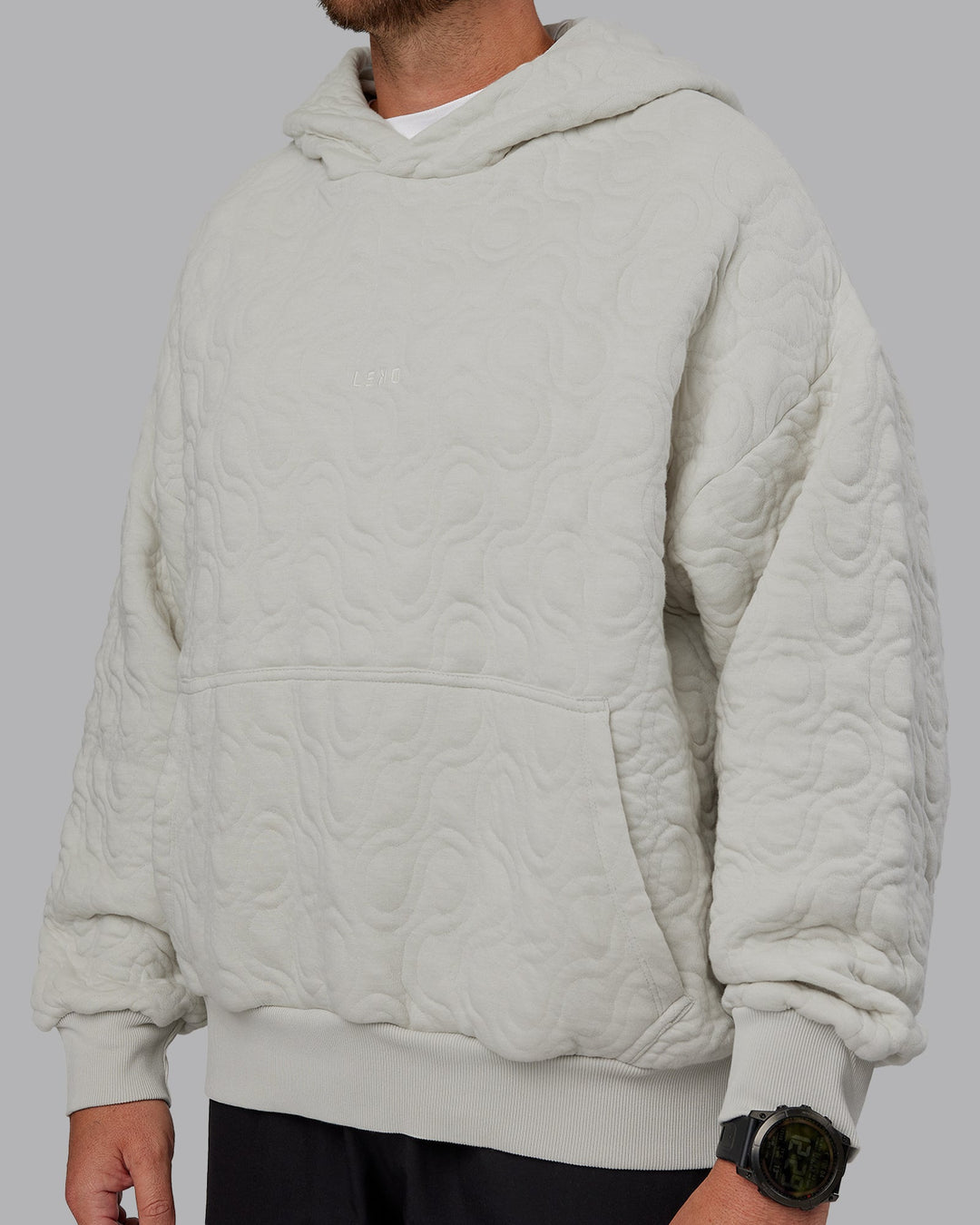 Man wearing MVP Quilted Oversized Hoodie in Digital Mist-Geometric | Model:Macca | Size:M