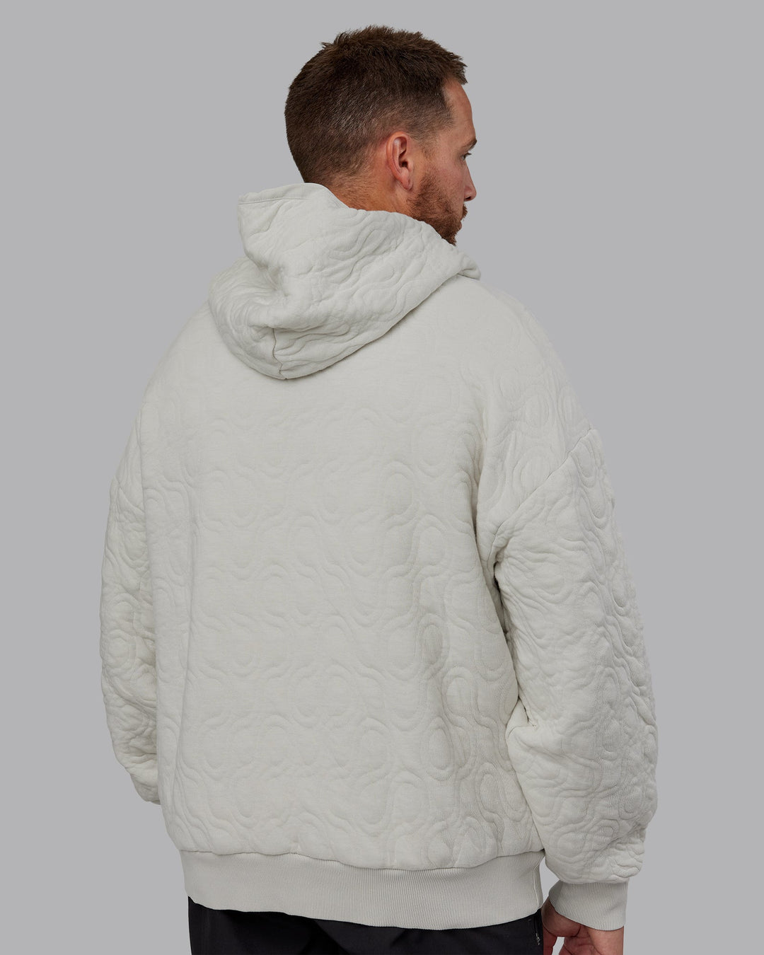 Man wearing MVP Quilted Oversized Hoodie in Digital Mist-Geometric | Model:Macca | Size:M