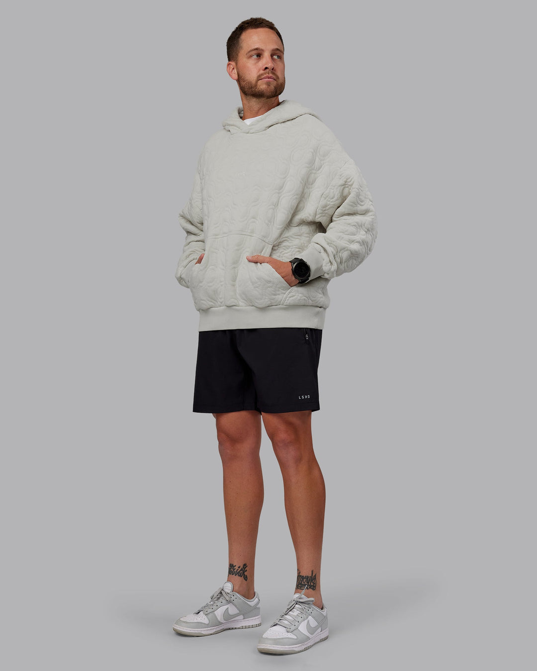 Man wearing MVP Quilted Oversized Hoodie in Digital Mist-Geometric | Model:Macca | Size:M