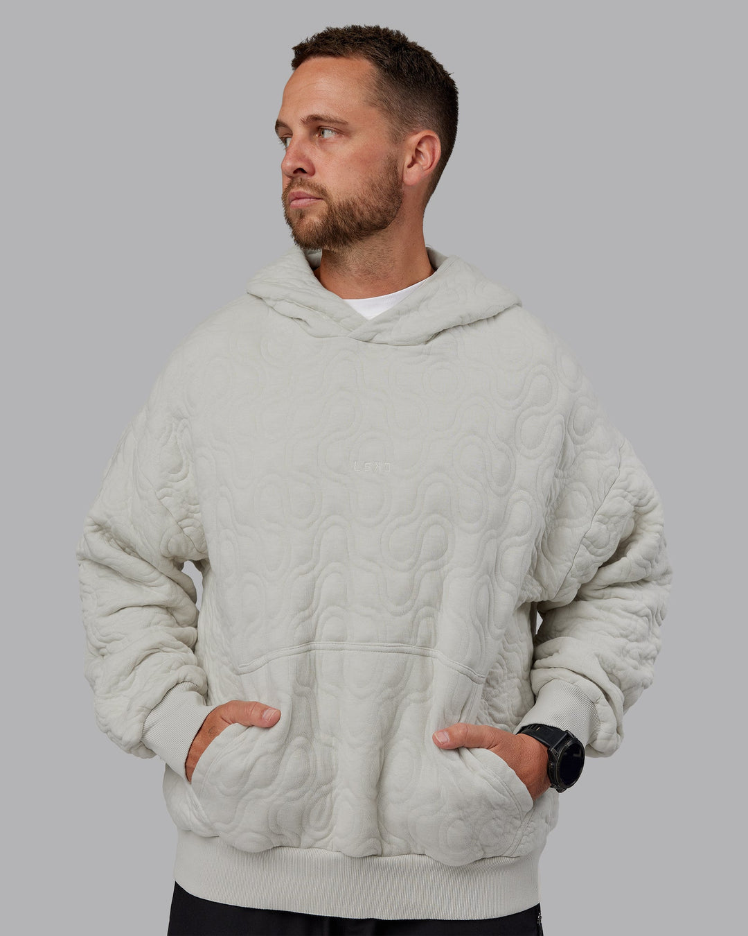 Man wearing MVP Quilted Oversized Hoodie in Digital Mist-Geometric | Model:Macca | Size:M