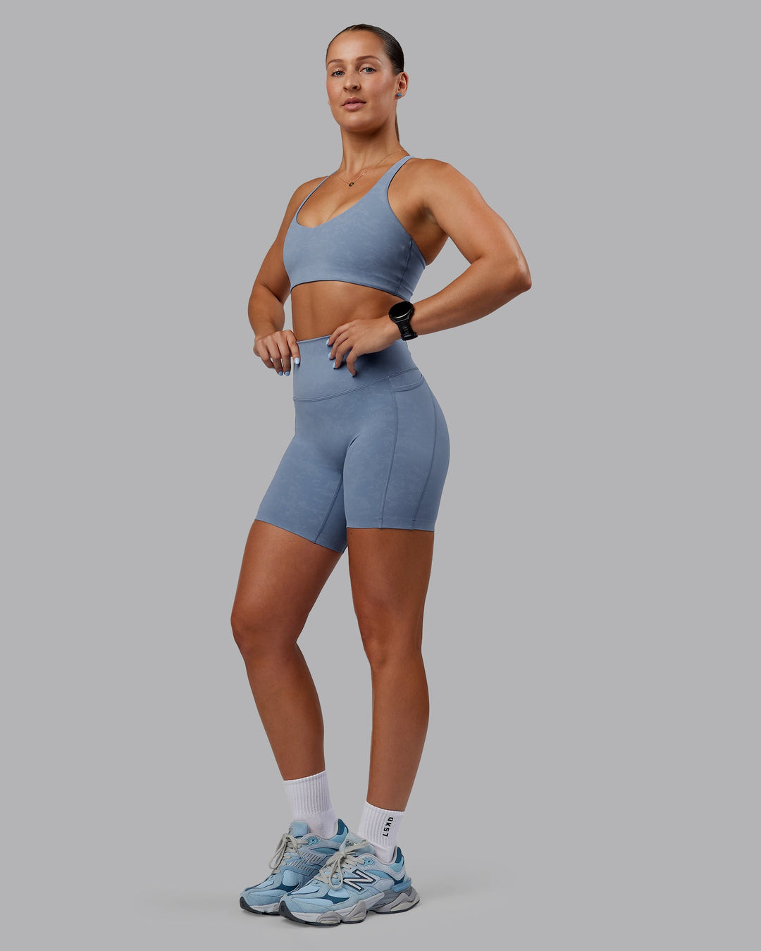 Woman wearing Abs Elixir Ultra High-Rise 6" Short Pockets - Infinity Mirage