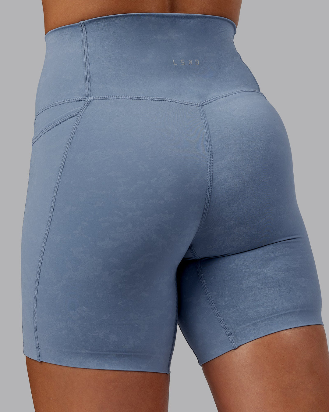 Woman wearing Abs Elixir Ultra High-Rise 6" Short Pockets - Infinity Mirage