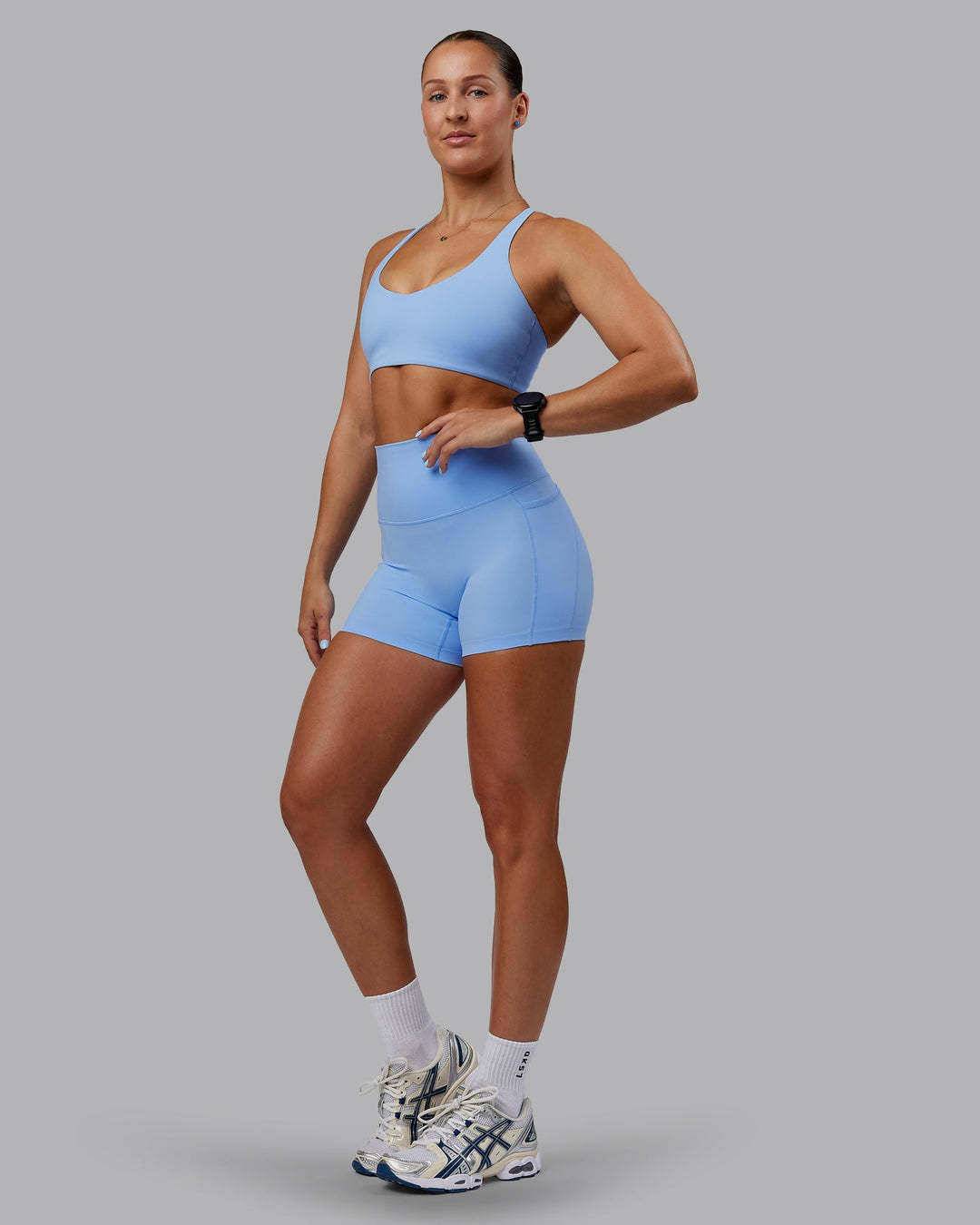 Woman wearing Abs Elixir Ultra High-Rise 4" Short Pockets - Open Air