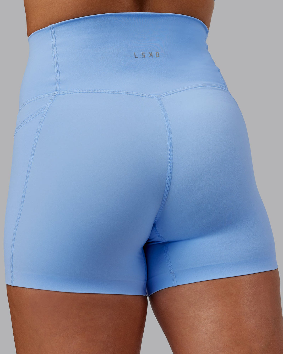 Woman wearing Abs Elixir Ultra High-Rise 4" Short Pockets - Open Air
