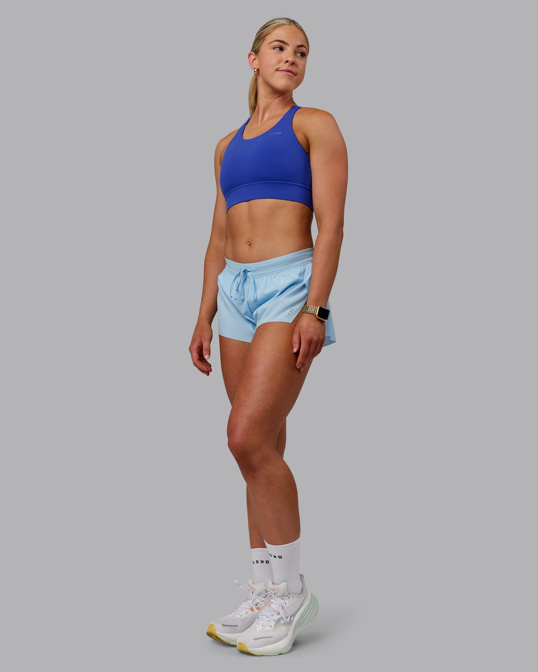 Woman wearing Accelerate 3" Run Shorts - Glacial Blue