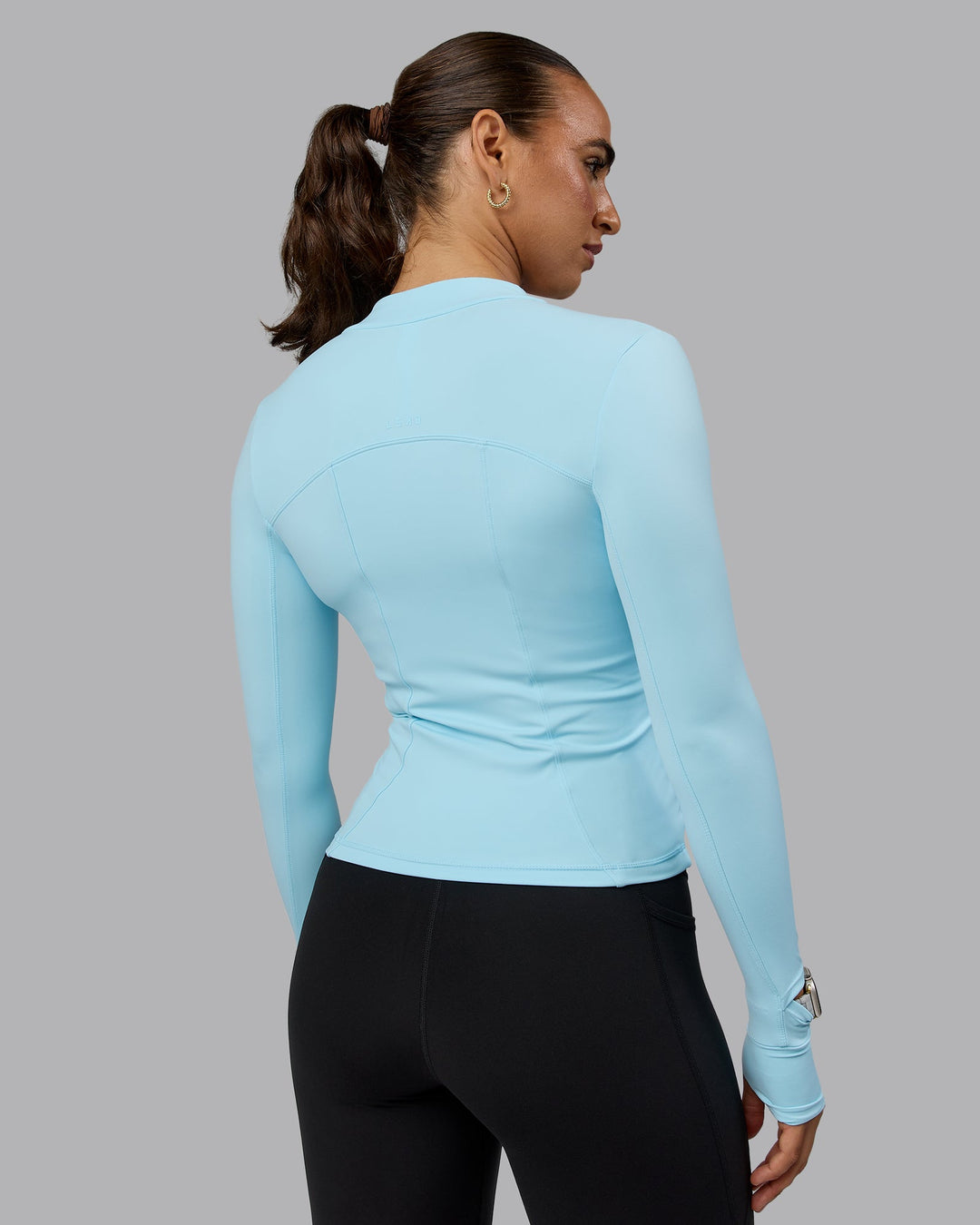 Woman wearing Aspire Jacket - Crystal Blue
