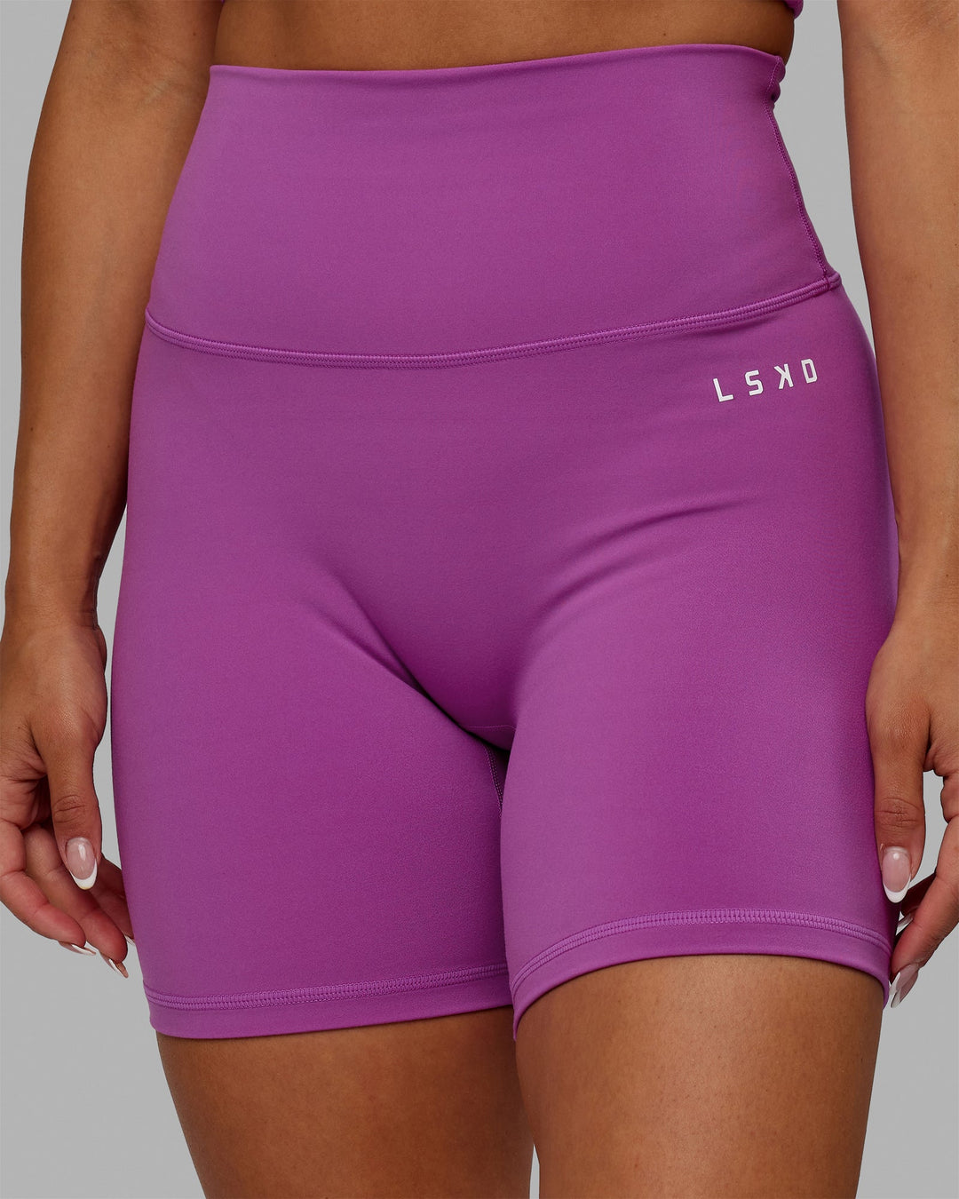 Woman wearing Base 2.0 Mid-Length Shorts - Hyper Violet