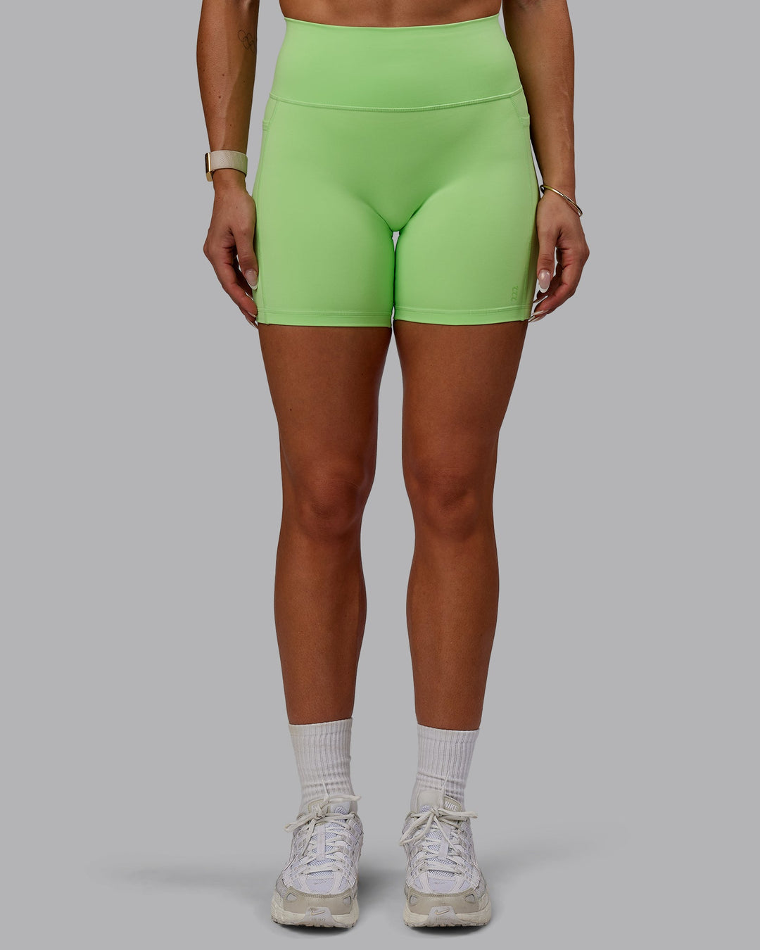 Woman wearing Bree Masters Fusion Ultra High-Rise 6" Short Pockets - Pastel Lime