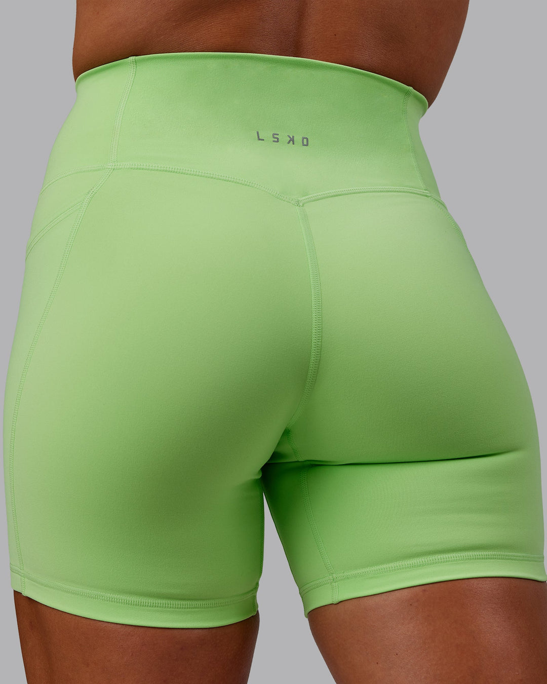 Woman wearing Bree Masters Fusion Ultra High-Rise 6" Short Pockets - Pastel Lime