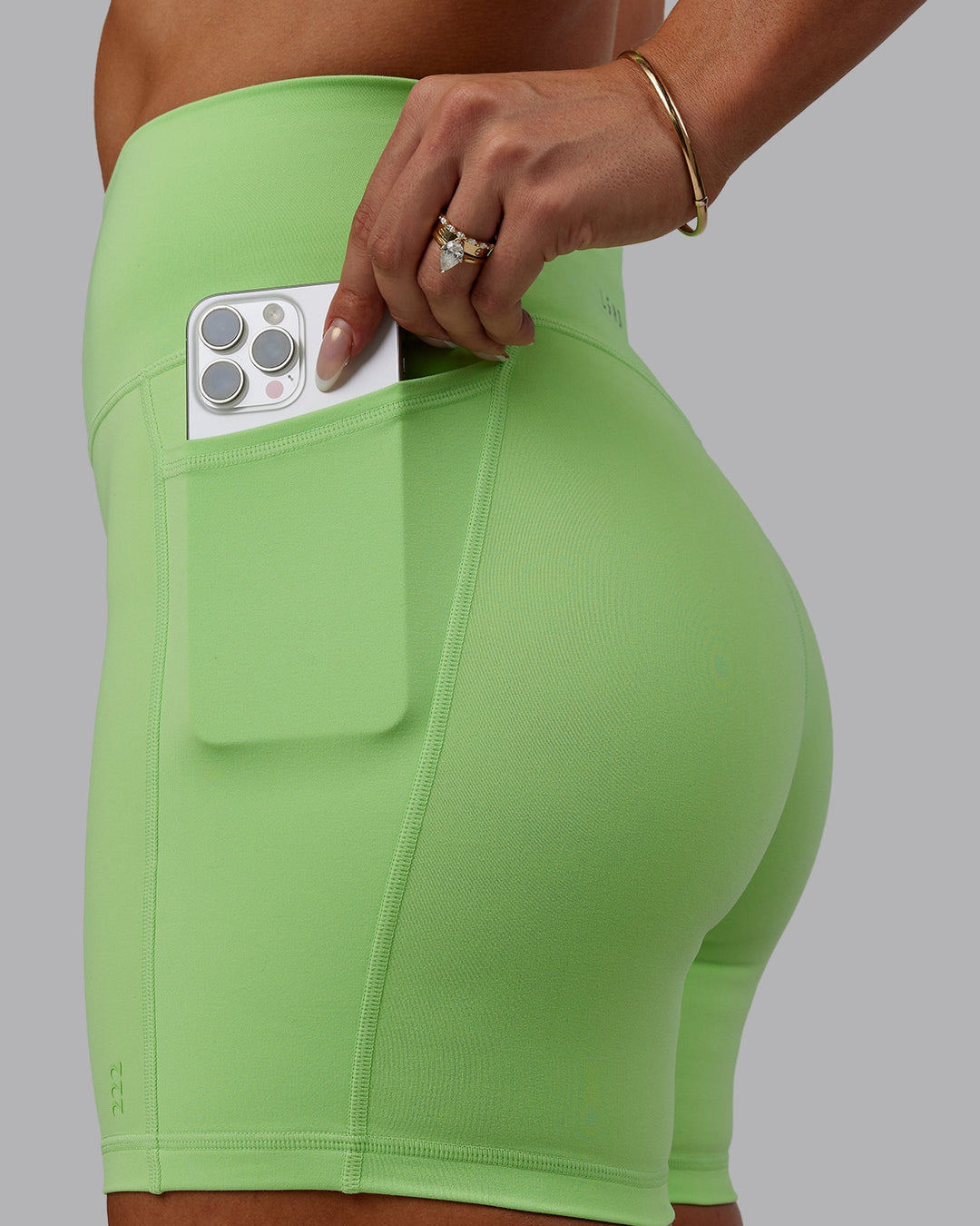 Woman wearing Bree Masters Fusion Ultra High-Rise 6" Short Pockets - Pastel Lime