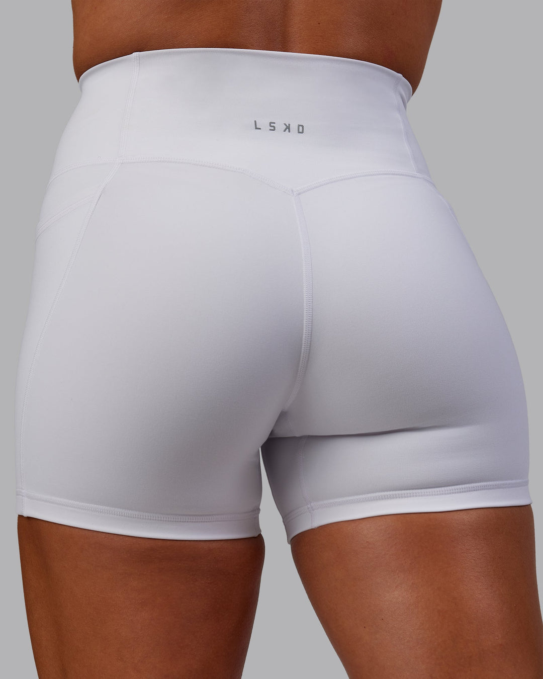 Woman wearing Bree Masters Fusion Ultra High-Rise 4" Short Pockets - White