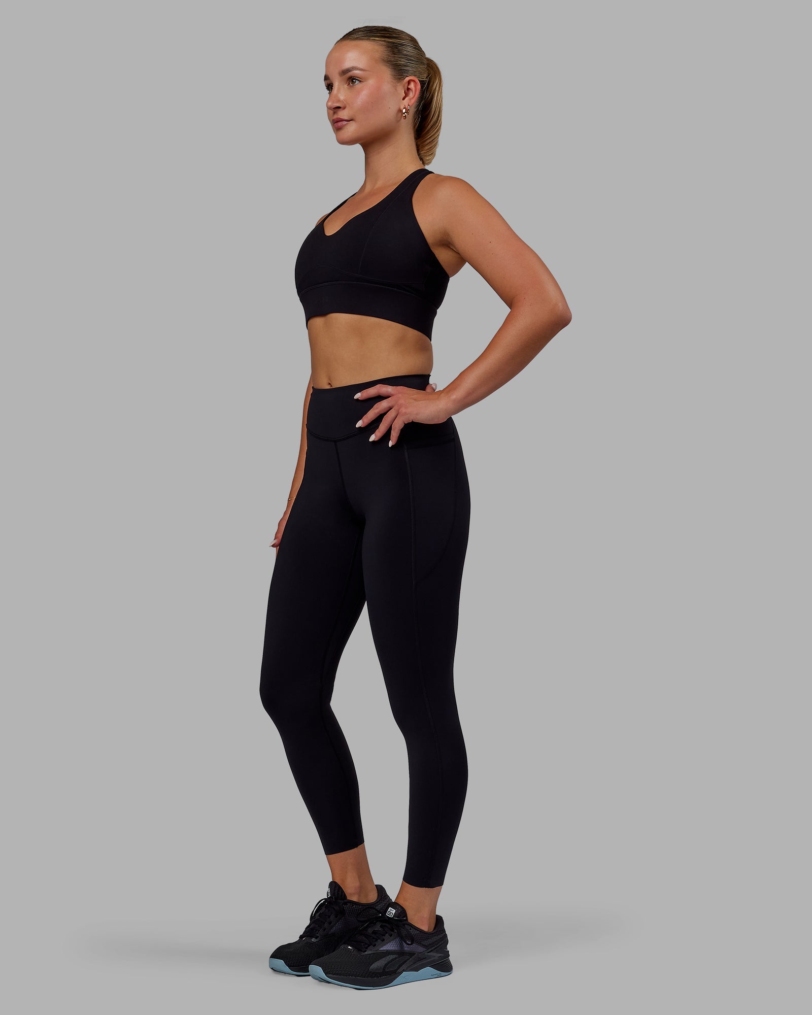 Woman wearing Elite High-Rise 7/8 Legging Pockets - Black