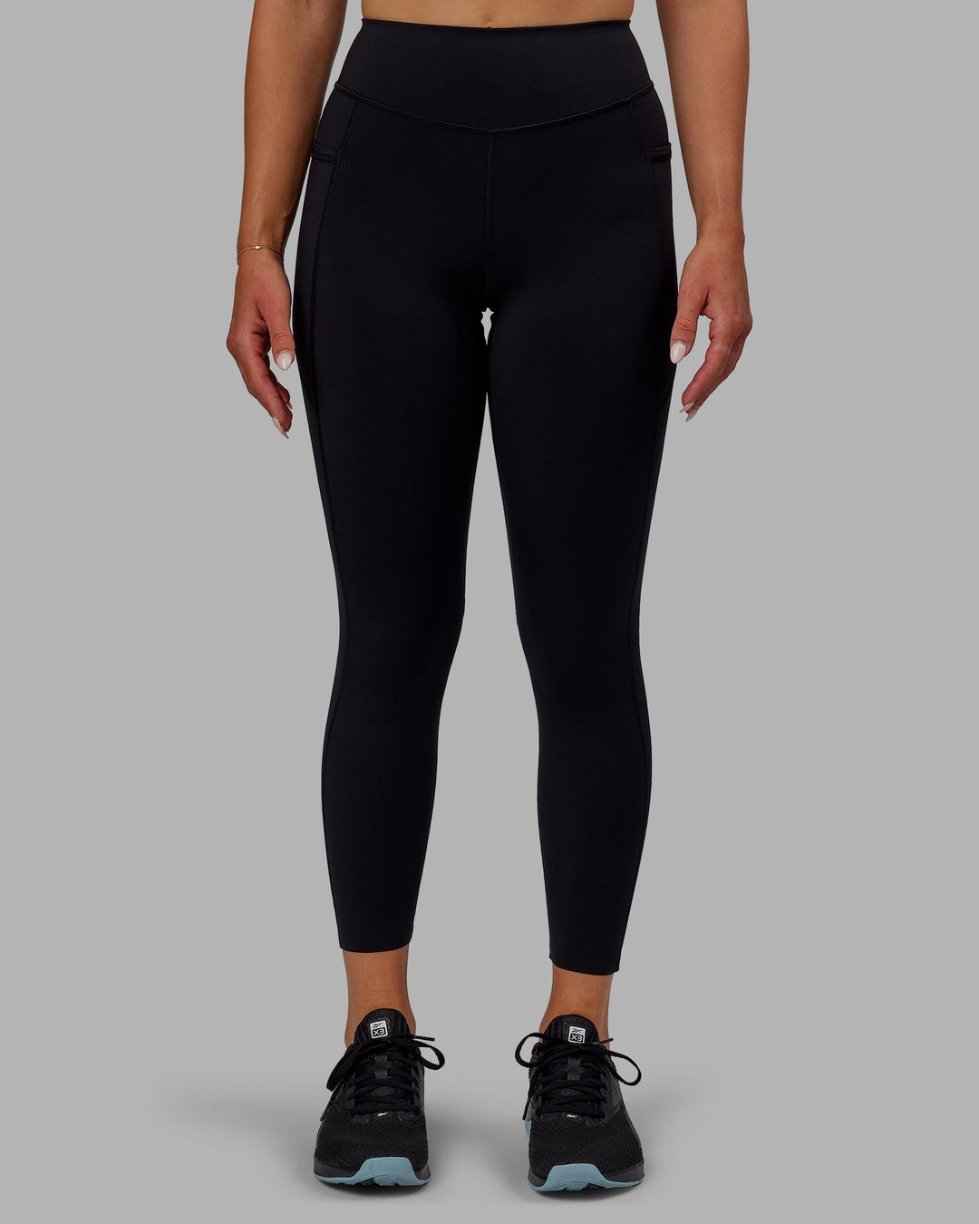 Woman wearing Elite High-Rise 7/8 Legging Pockets - Black